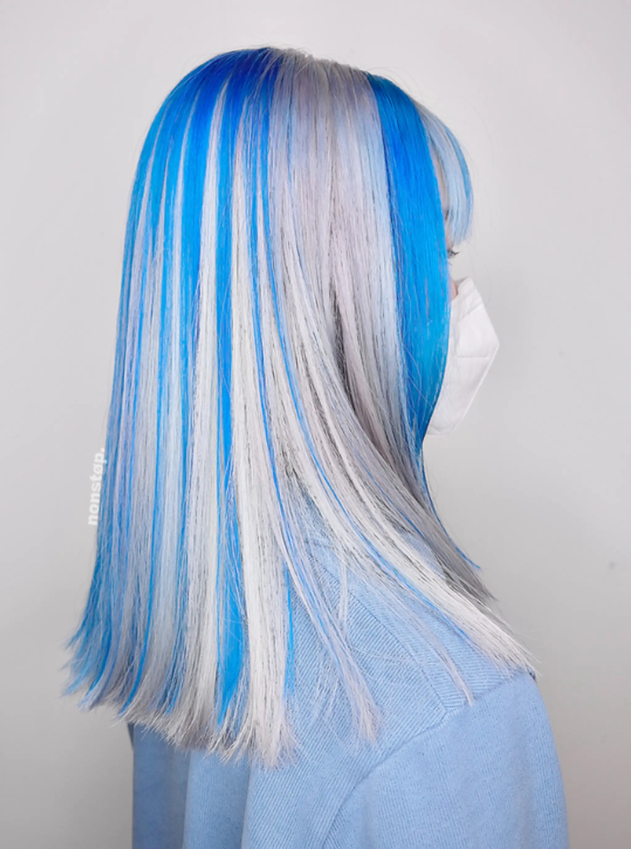 Medium-length, straight hair in bold blue with striking silver and white highlights, featuring a layered cut with a side-part and precision-cut ends.
(NonstopStyle: by Vincent) 1