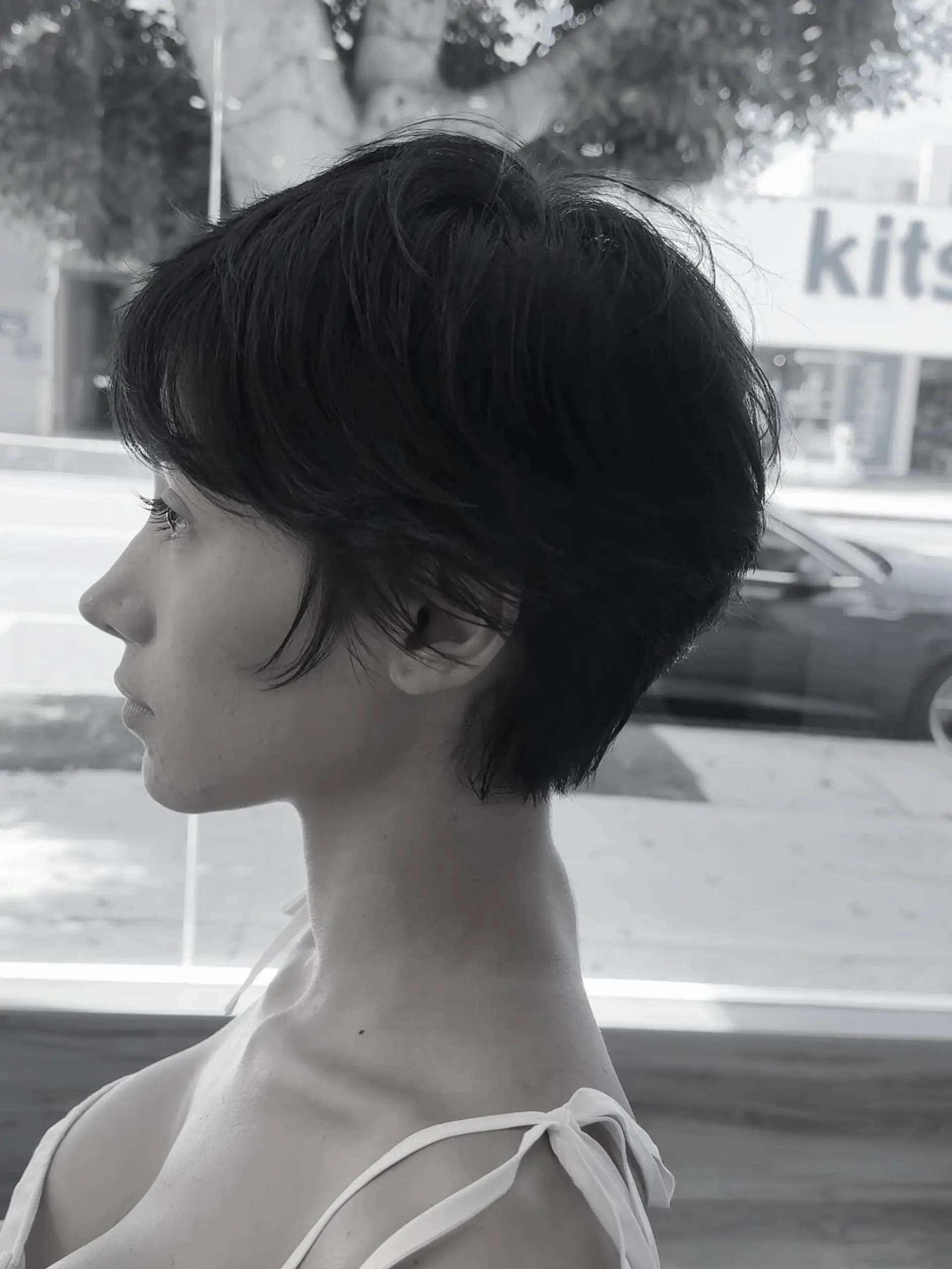 A soft, textured pixie cut with wispy ear-framing pieces and a softly tapered neckline. 1