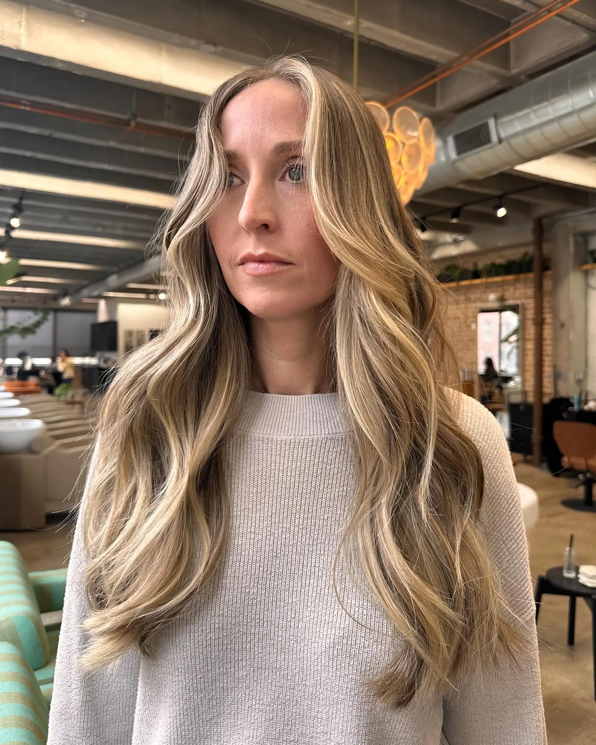 Long wavy hair with a balayage coloring and face-framing layers. 1