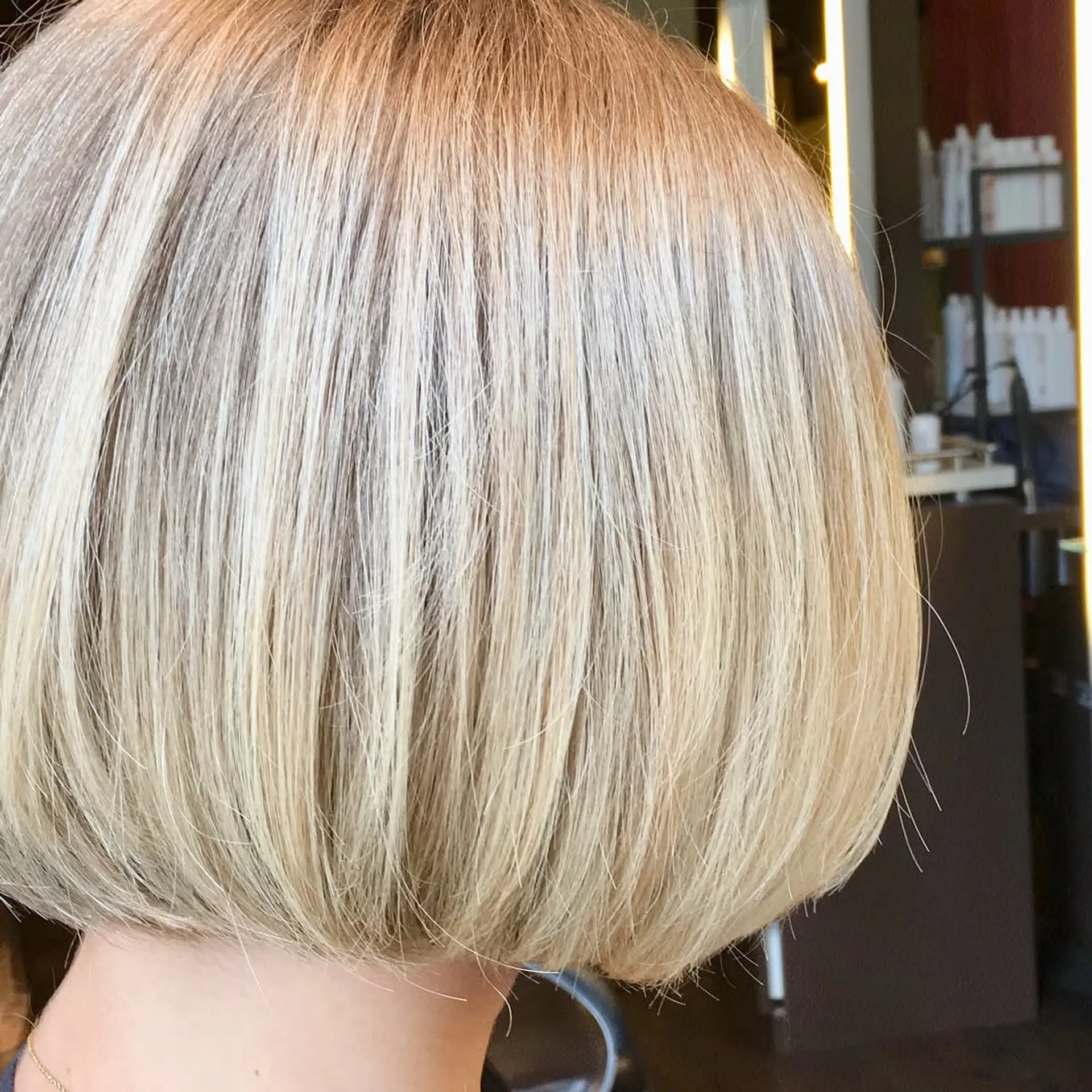 A trendy blunt bob, precisely cut to chin length with an icy platinum blonde color. 2
