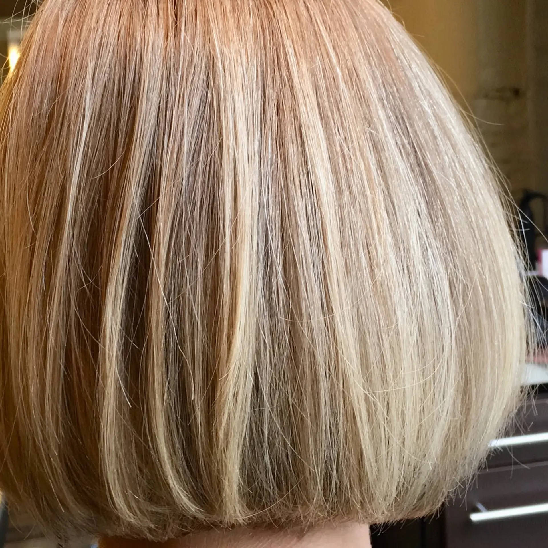 A trendy blunt bob, precisely cut to chin length with an icy platinum blonde color. 3