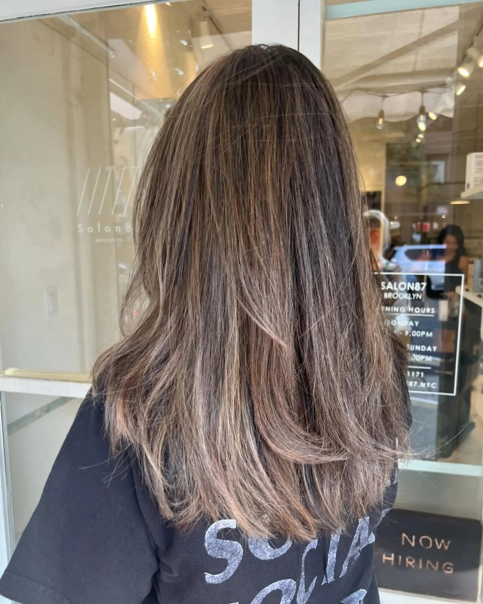 Long, wavy hair with a layered cut, featuring brown base and ashy blonde highlights for a natural, sun-kissed effect. 1