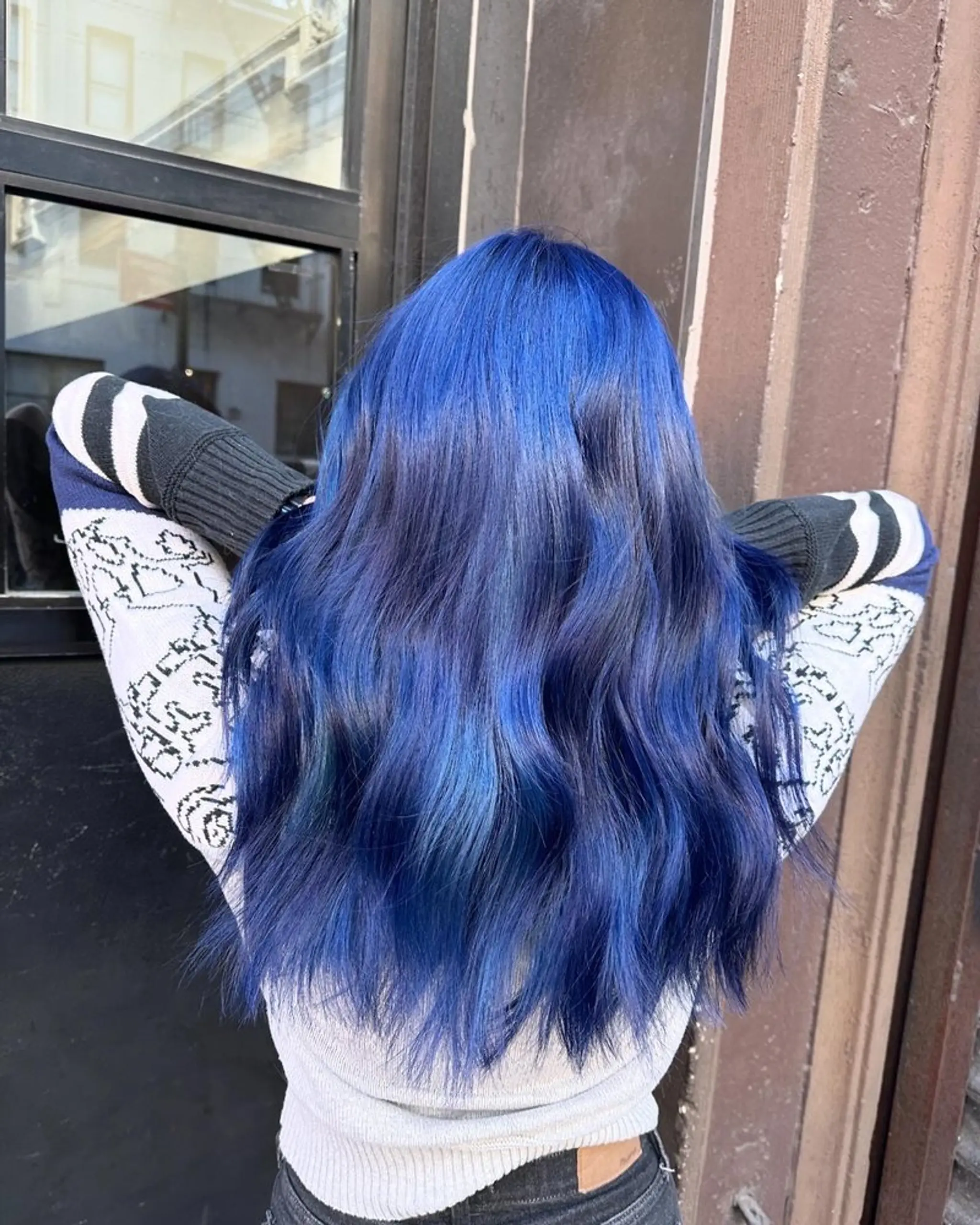 Long, wavy blue hair with rich, vibrant tones cascading down the back.
