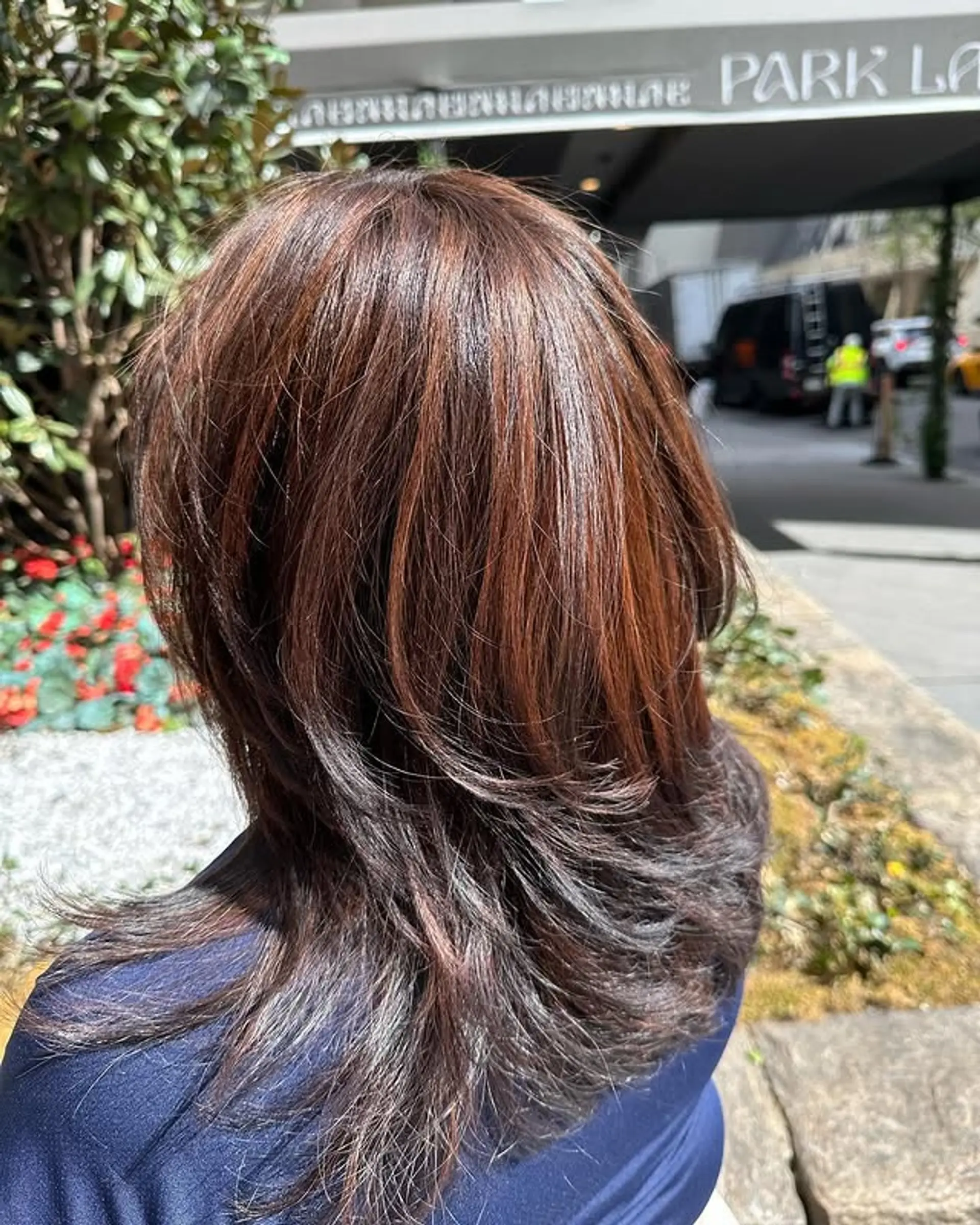 A medium-length layered haircut with soft, textured layers and a subtle balayage. 1