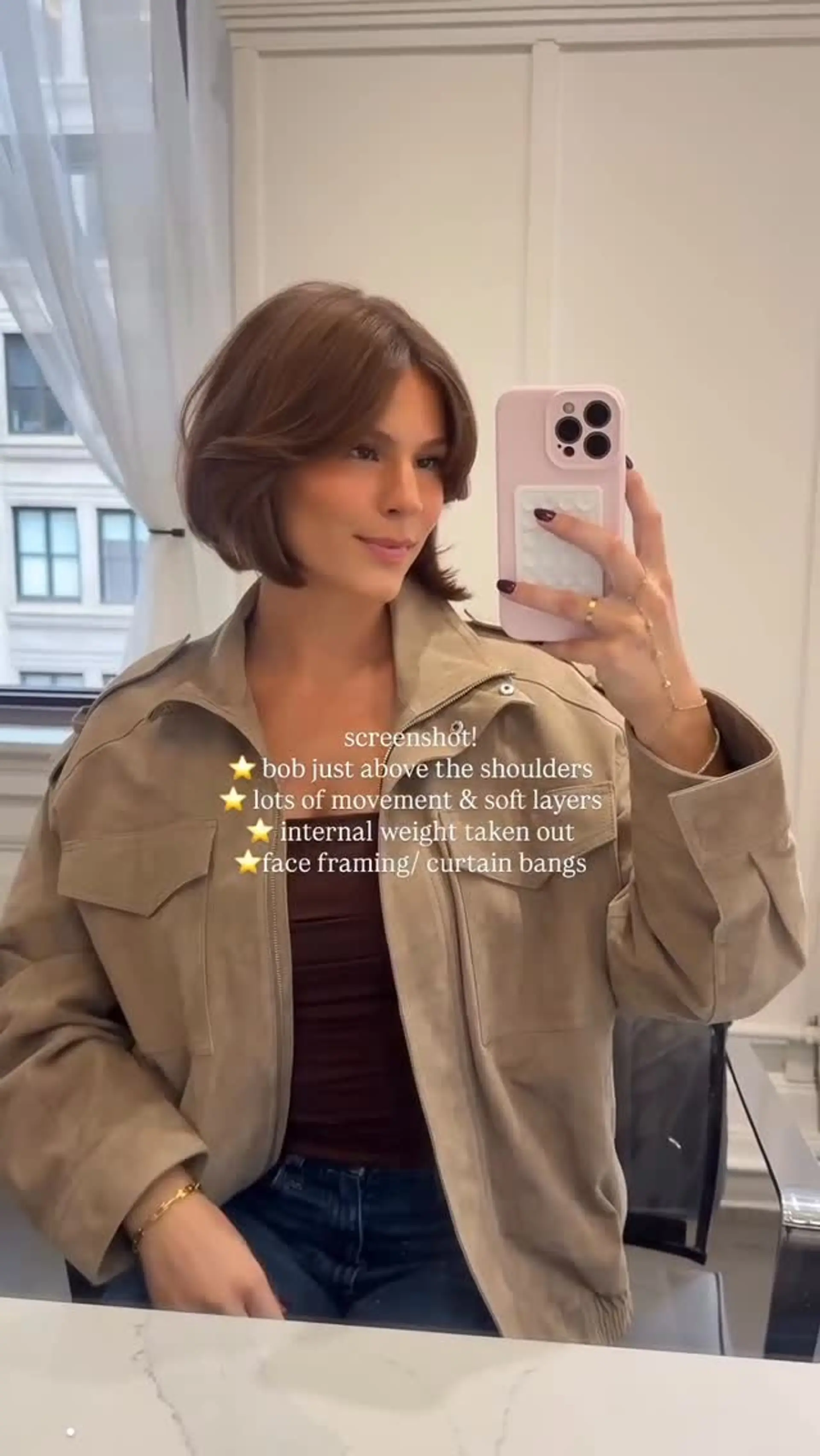 A voluminous, chin-to-neck length layered bob with center-parted curtain bangs styled with soft, rounded movement. 1