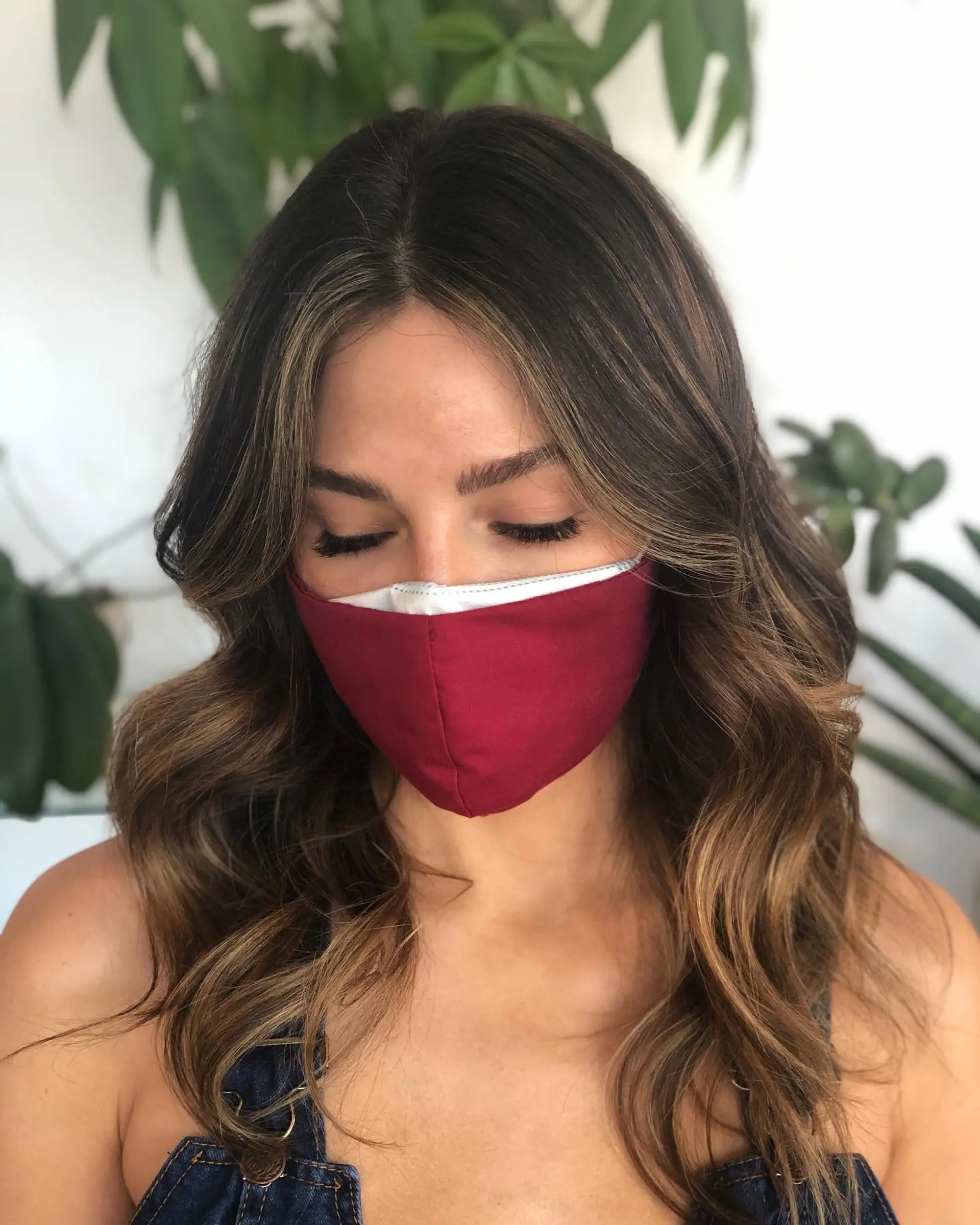 Long brunette hair styled in loose waves with seamless caramel balayage and soft face-framing babylights. 1