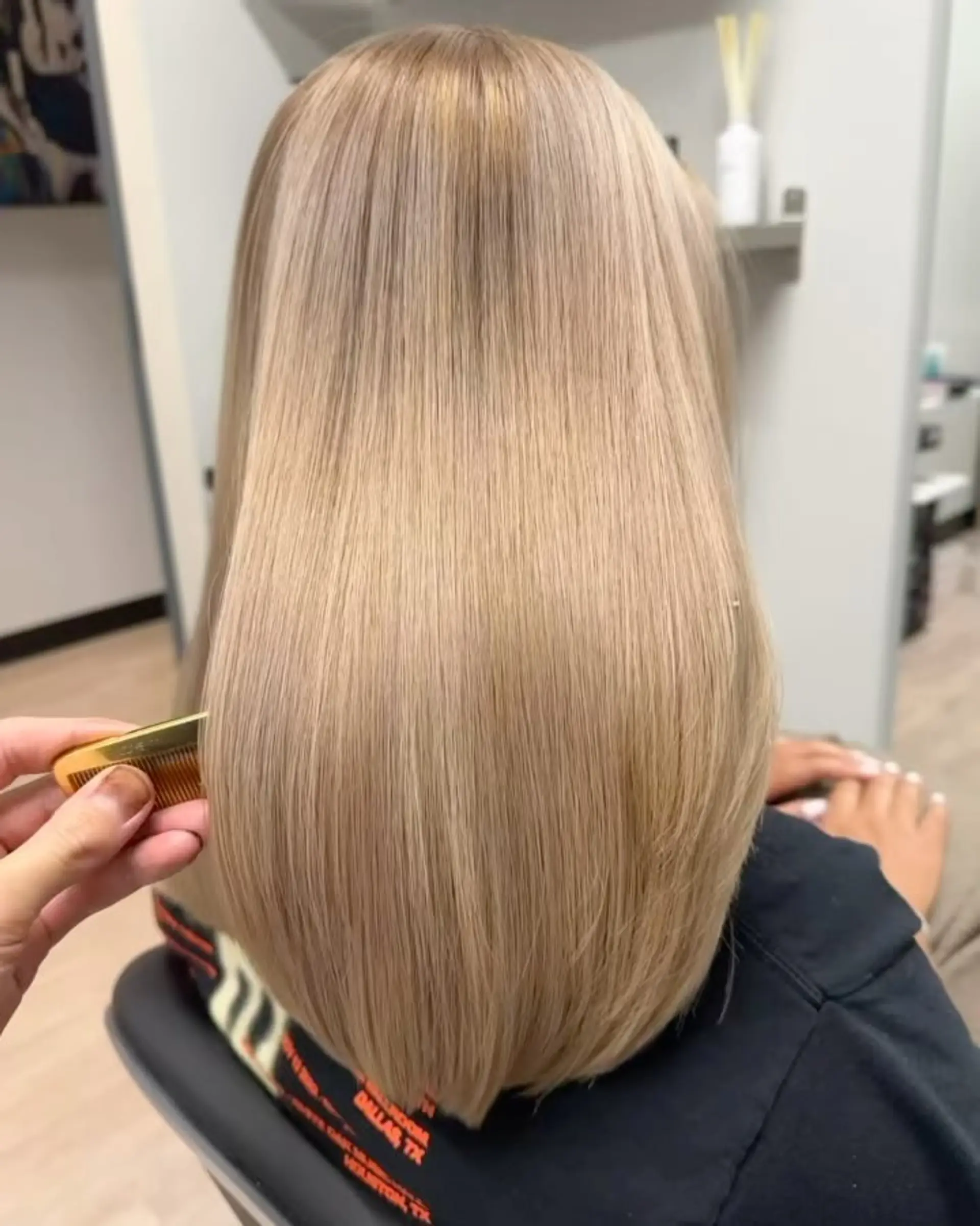 Sleek, glossy straight blonde hair with smooth texture and soft curved ends. 1