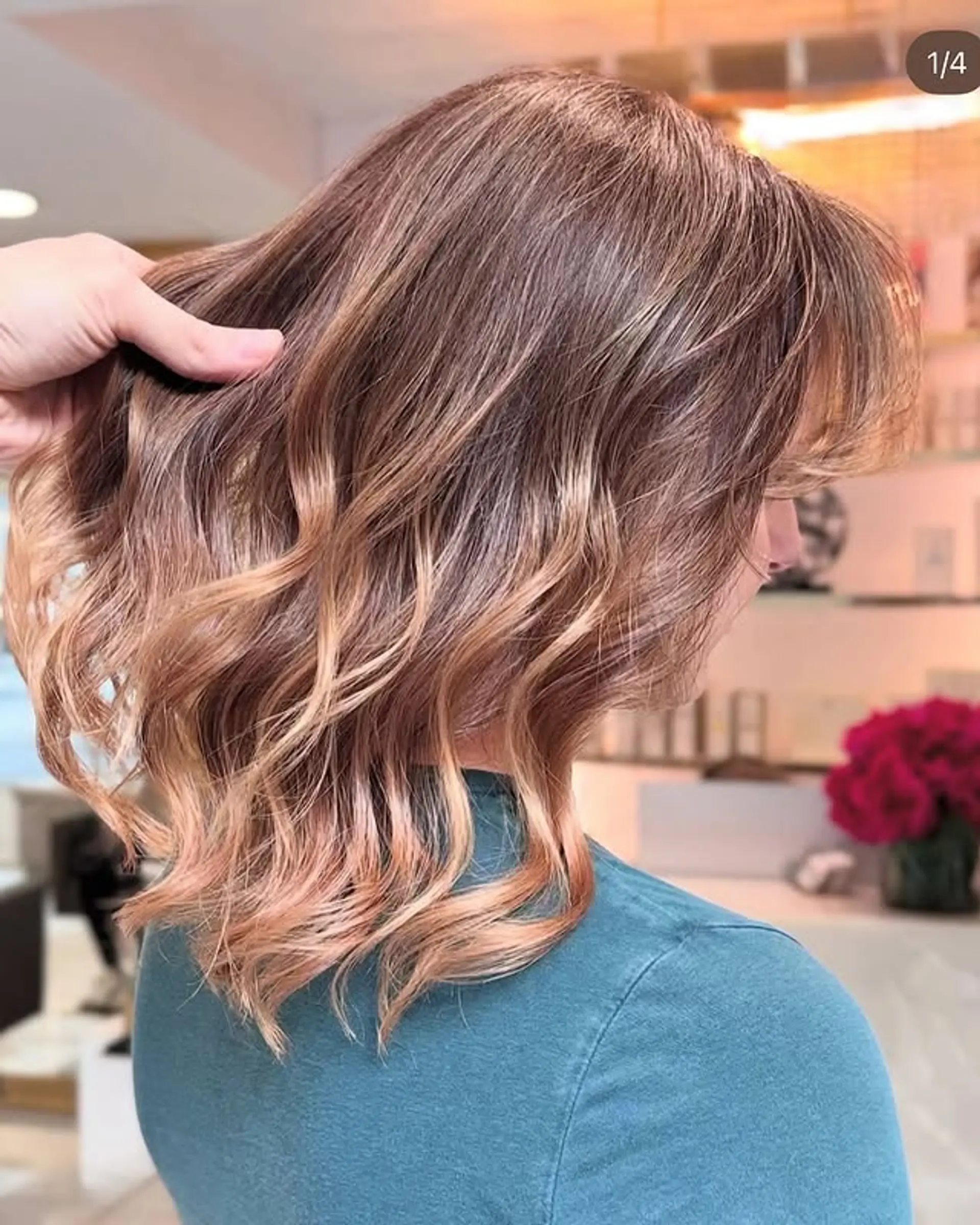 A wavy medium-length bob with face-framing layers and a copper balayage. 1
