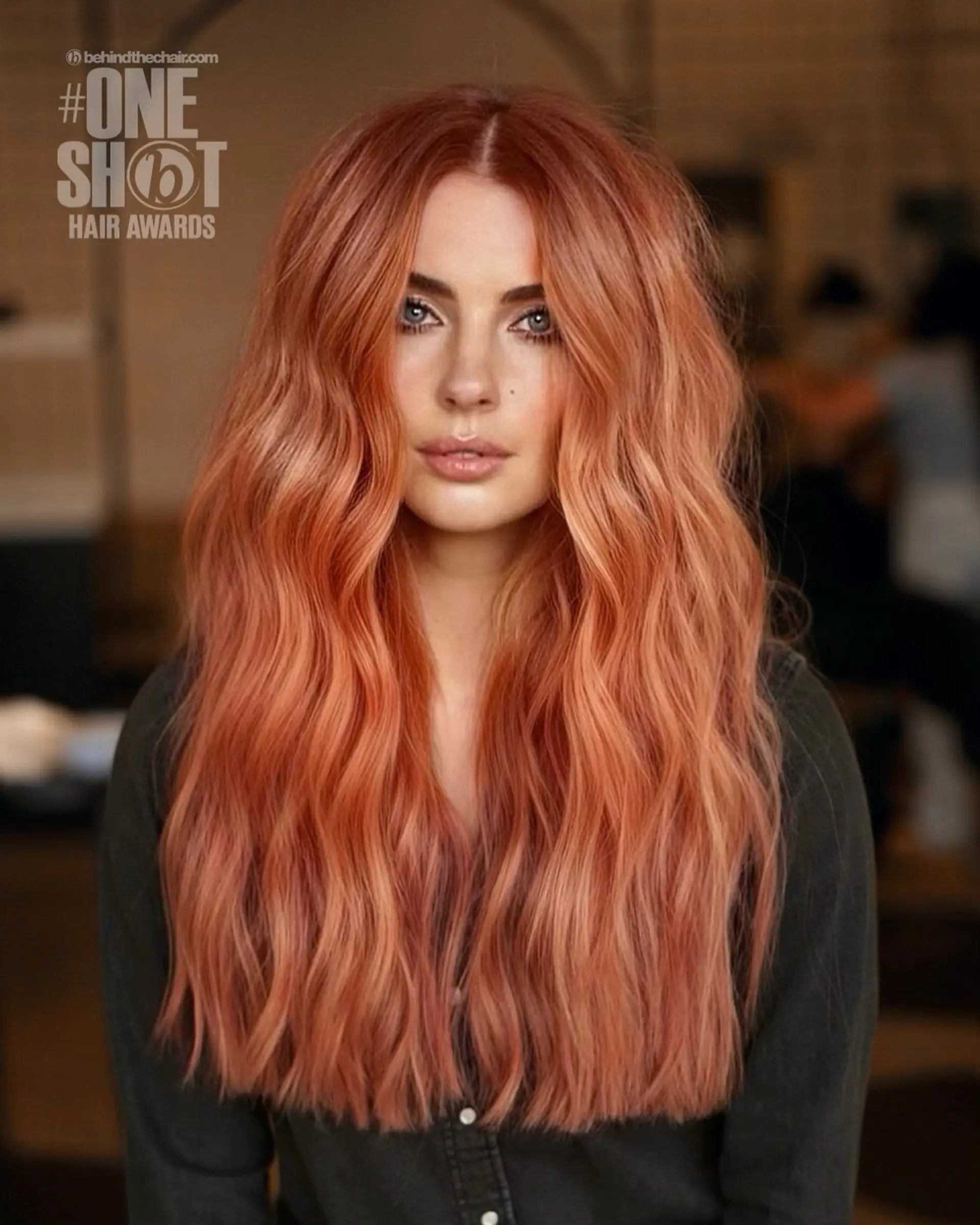 Long, voluminous rose gold hair styled in soft, loose waves with a defined middle part. 1