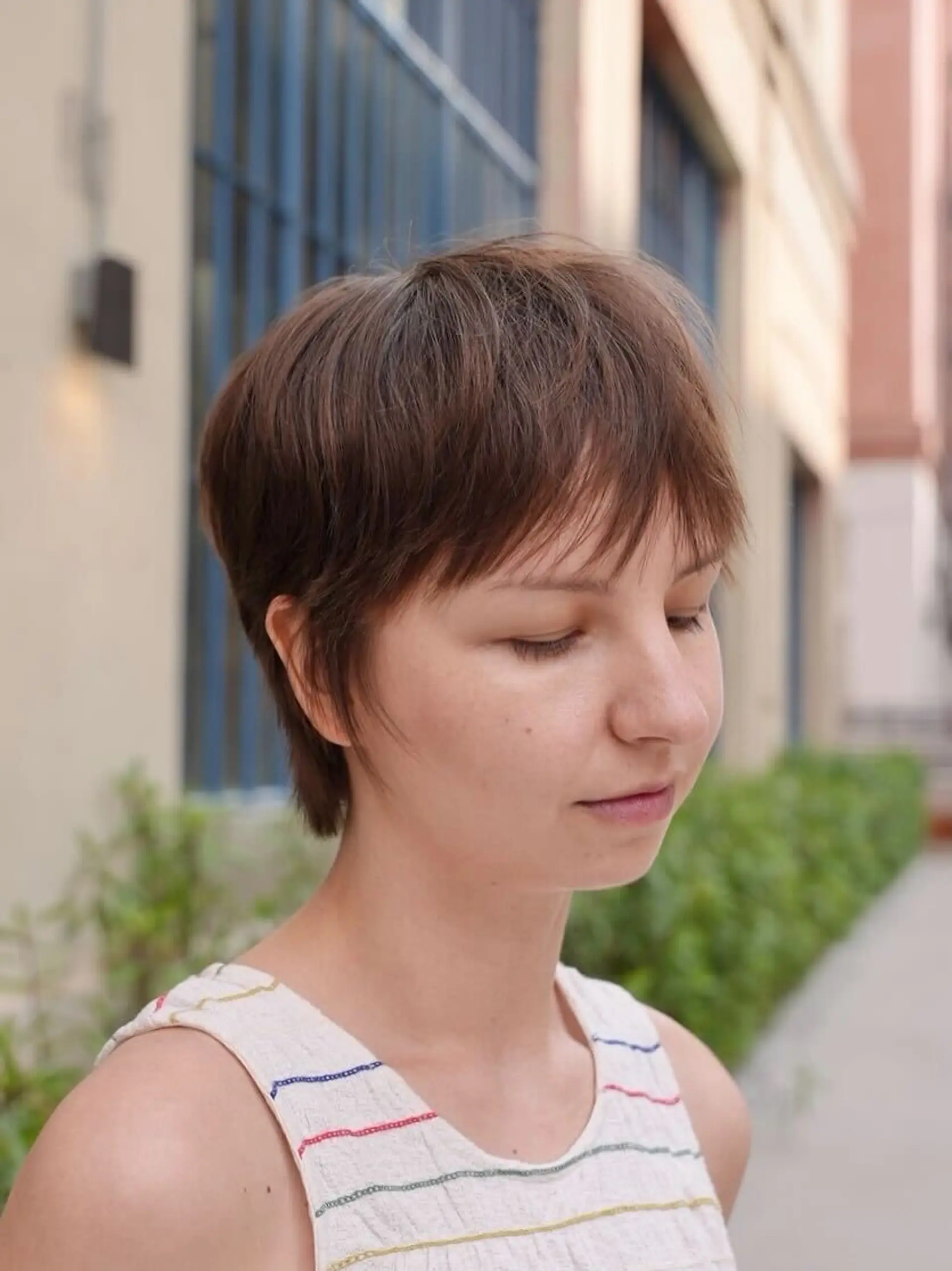 A soft, textured pixie cut with wispy, face-framing fringe and subtle tapered sides. 1