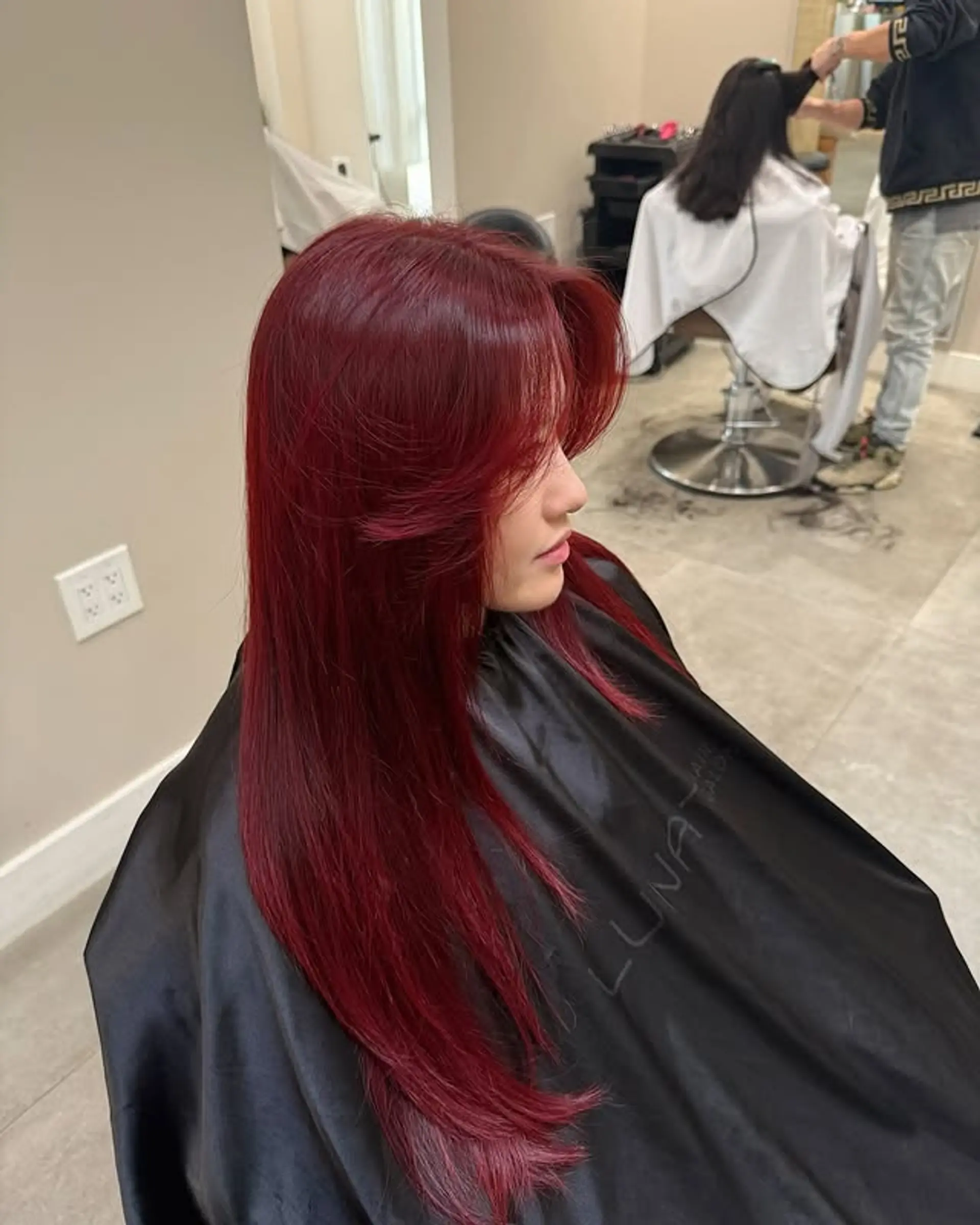 Long layered hairstyle with face-framing layers and curtain bangs. 1