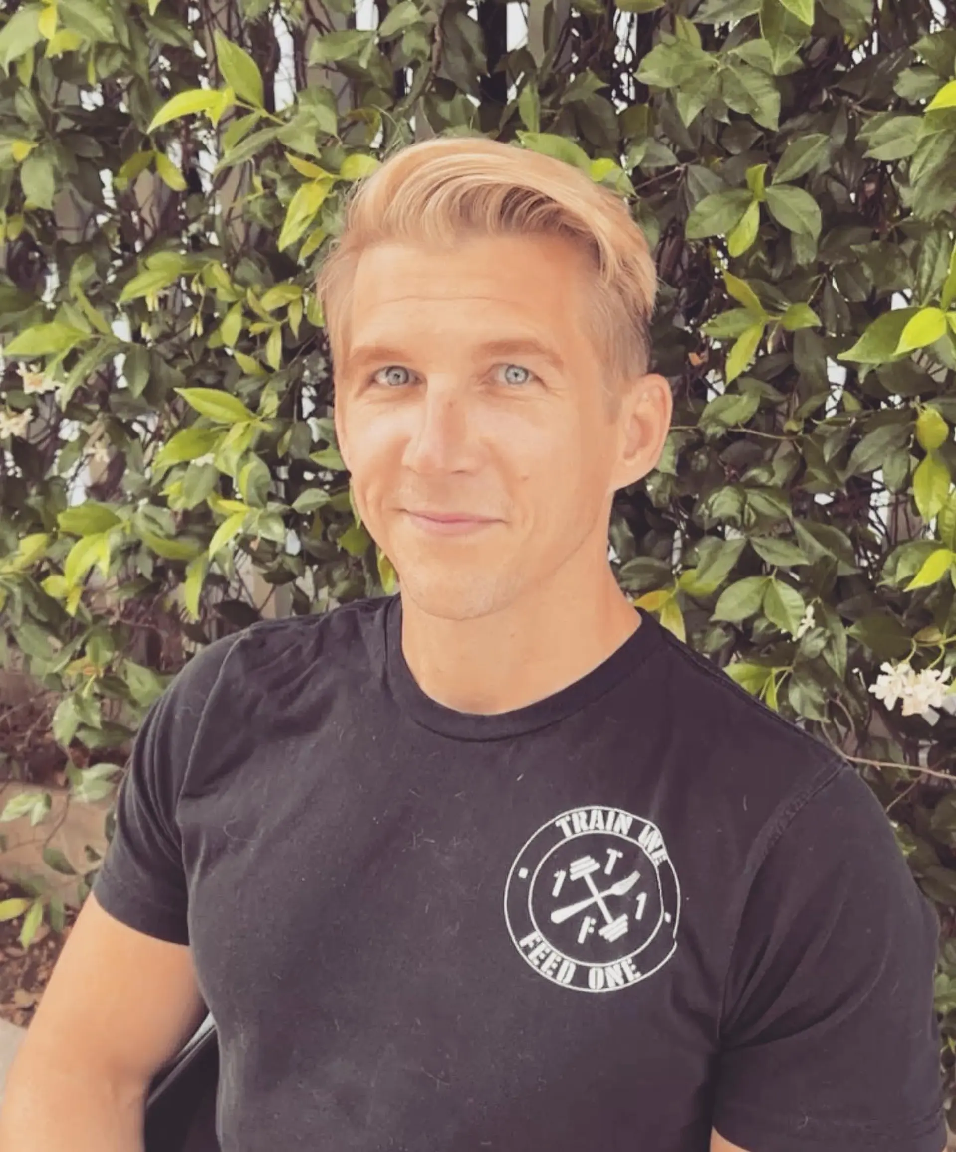 A men's short haircut featuring side-swept volume in a luminous warm golden blonde tone. 1