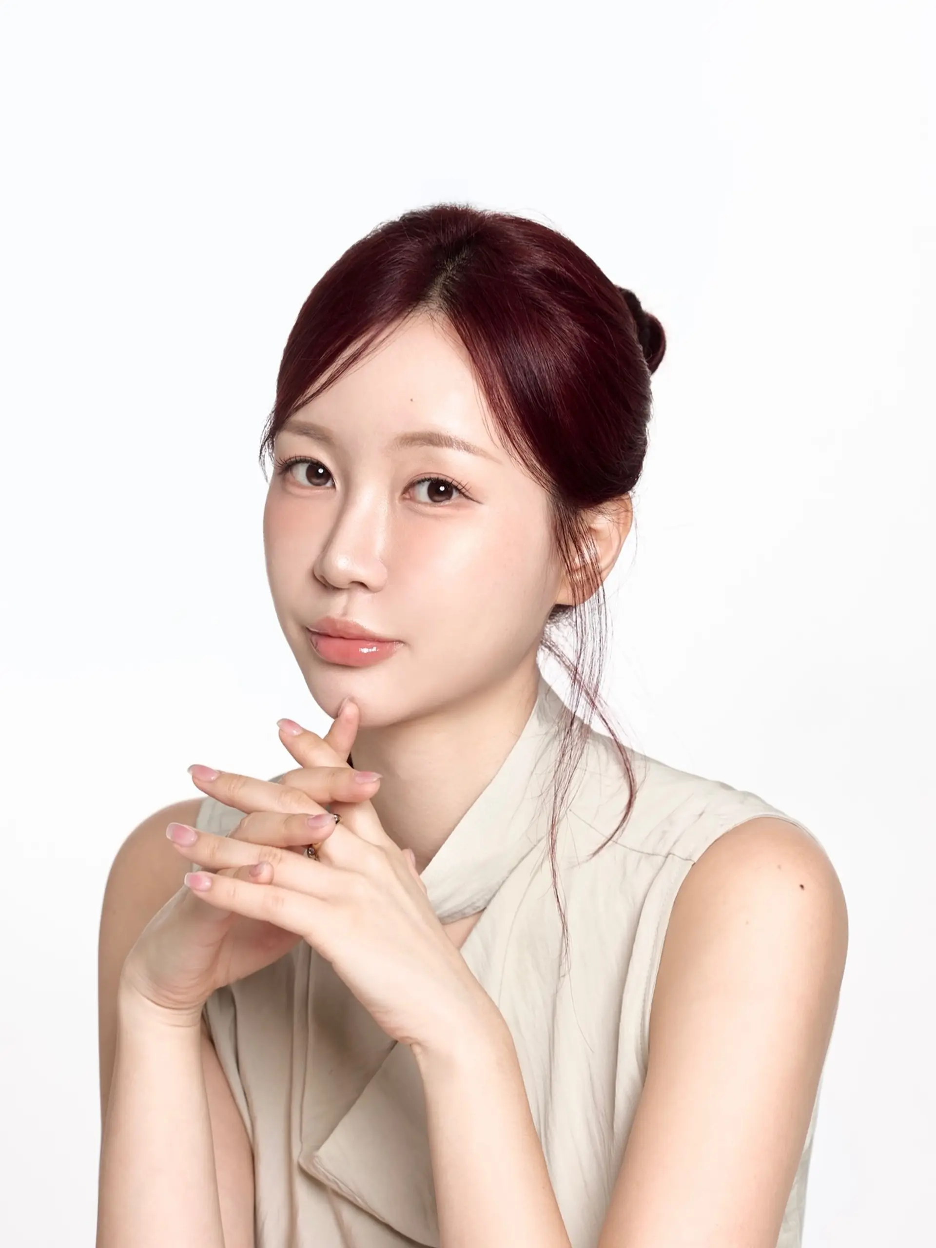 A sophisticated updo styled in a rich burgundy shade, parted down the center with soft face-framing strands. 1