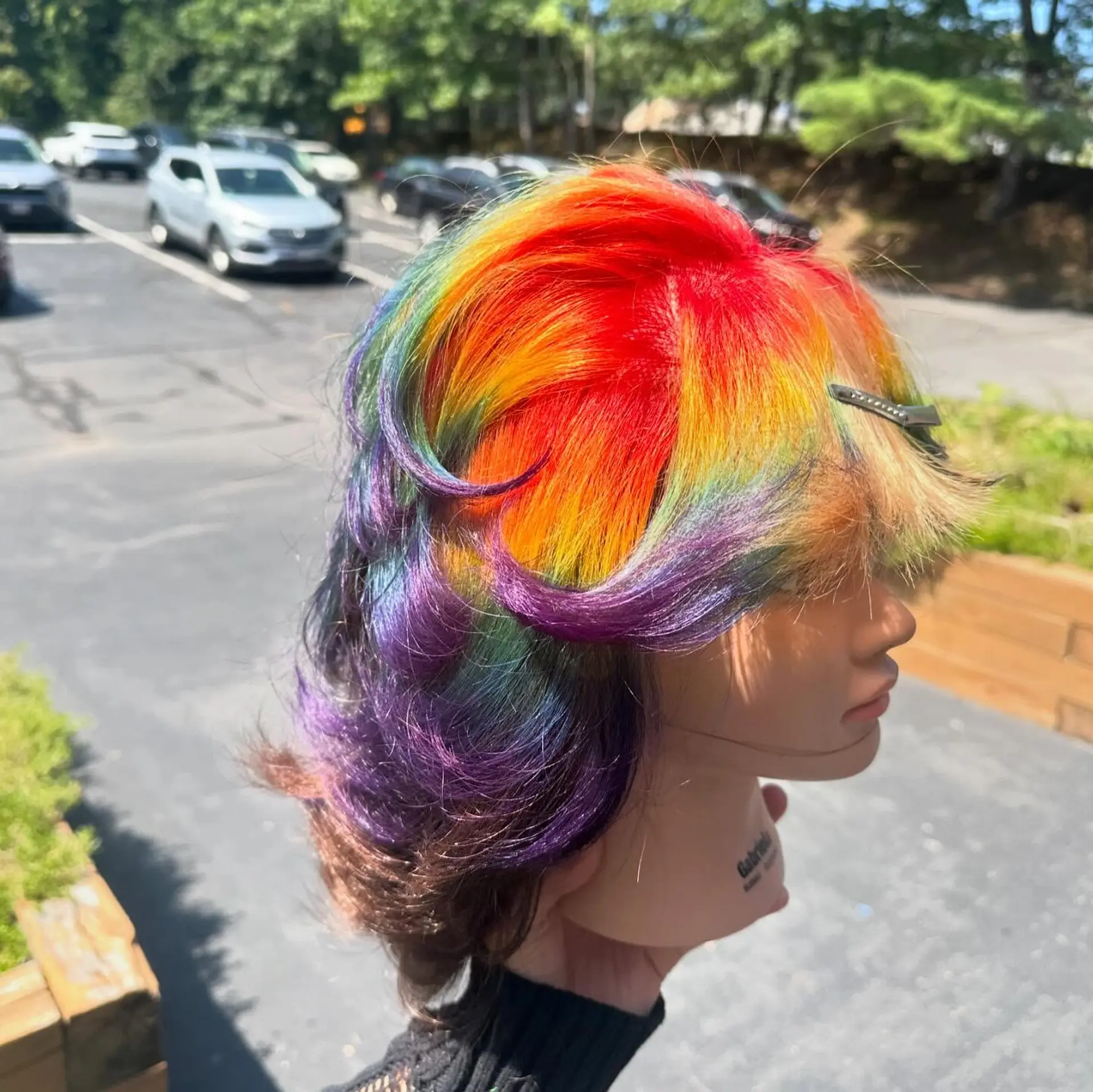A creative vivid rainbow prism color design placed over a short, textured layered shag with flipped ends and face-framing fringe. 1