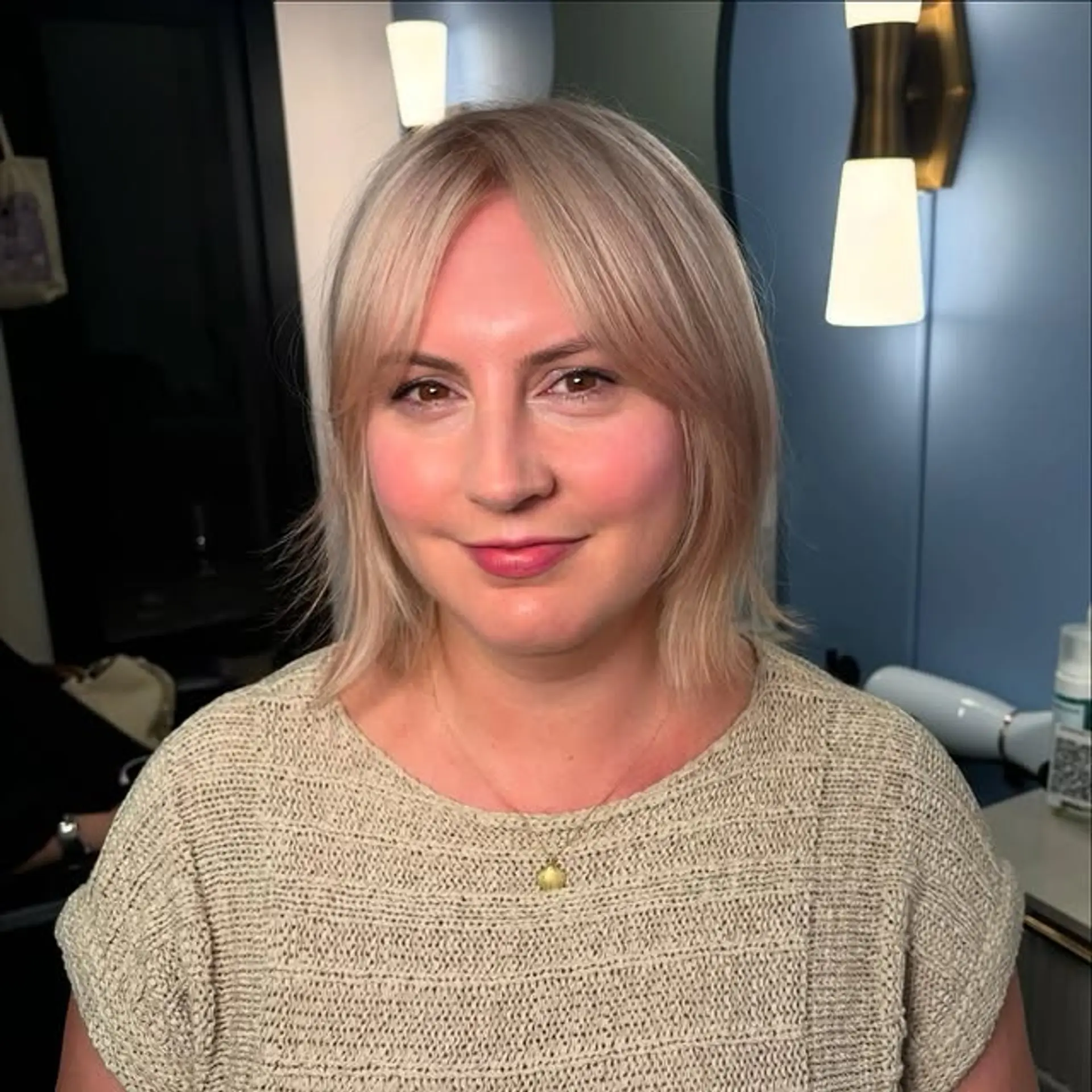 A medium-length bob with bangs, styled in an icy platinum blonde color. 1