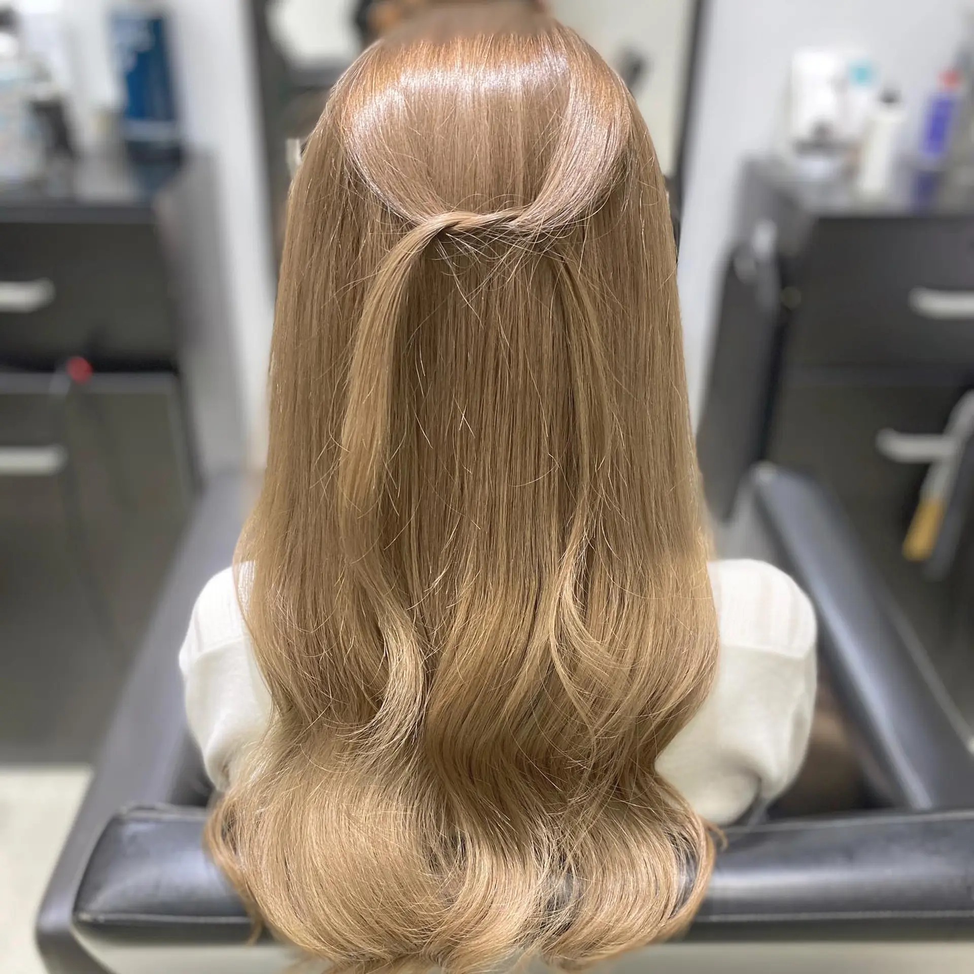 Long, wavy honey blonde hair styled in loose waves with a half-updo. 1