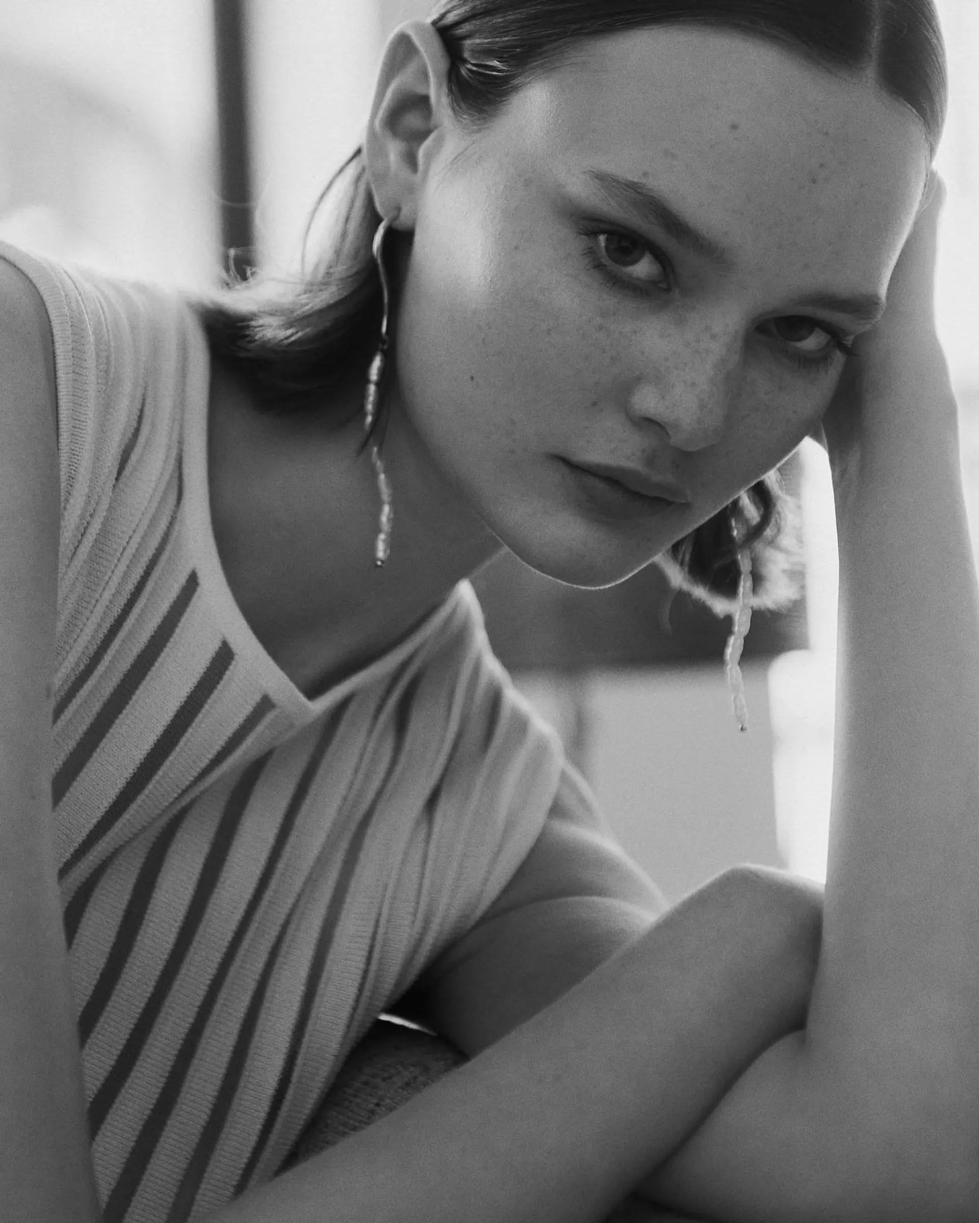 A minimalist, sleek bob styled with a crisp center part and smoothly tucked behind the ears. 1