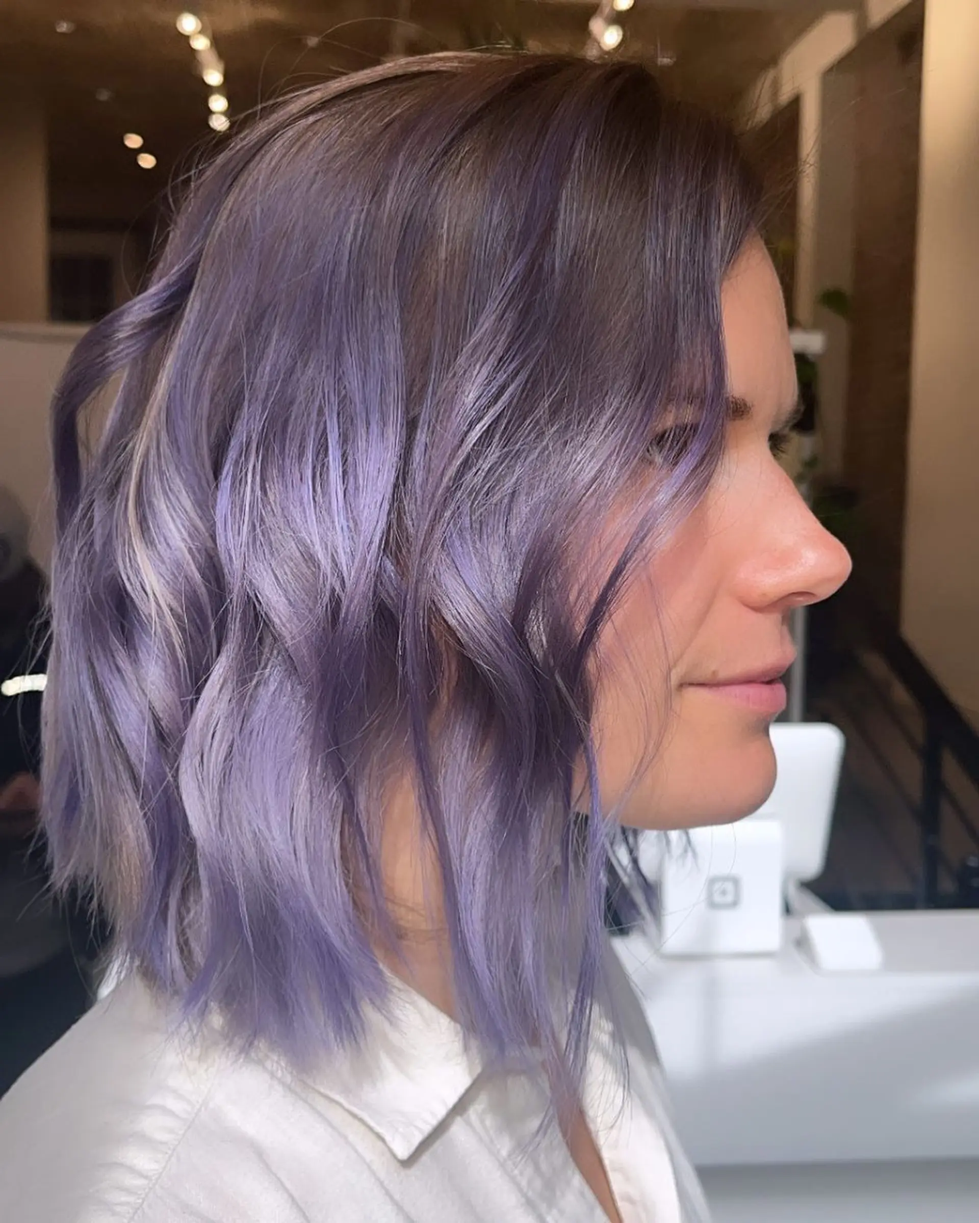 Medium-length bob with soft waves, side part, and stunning lavender and purple two-tone color. 1