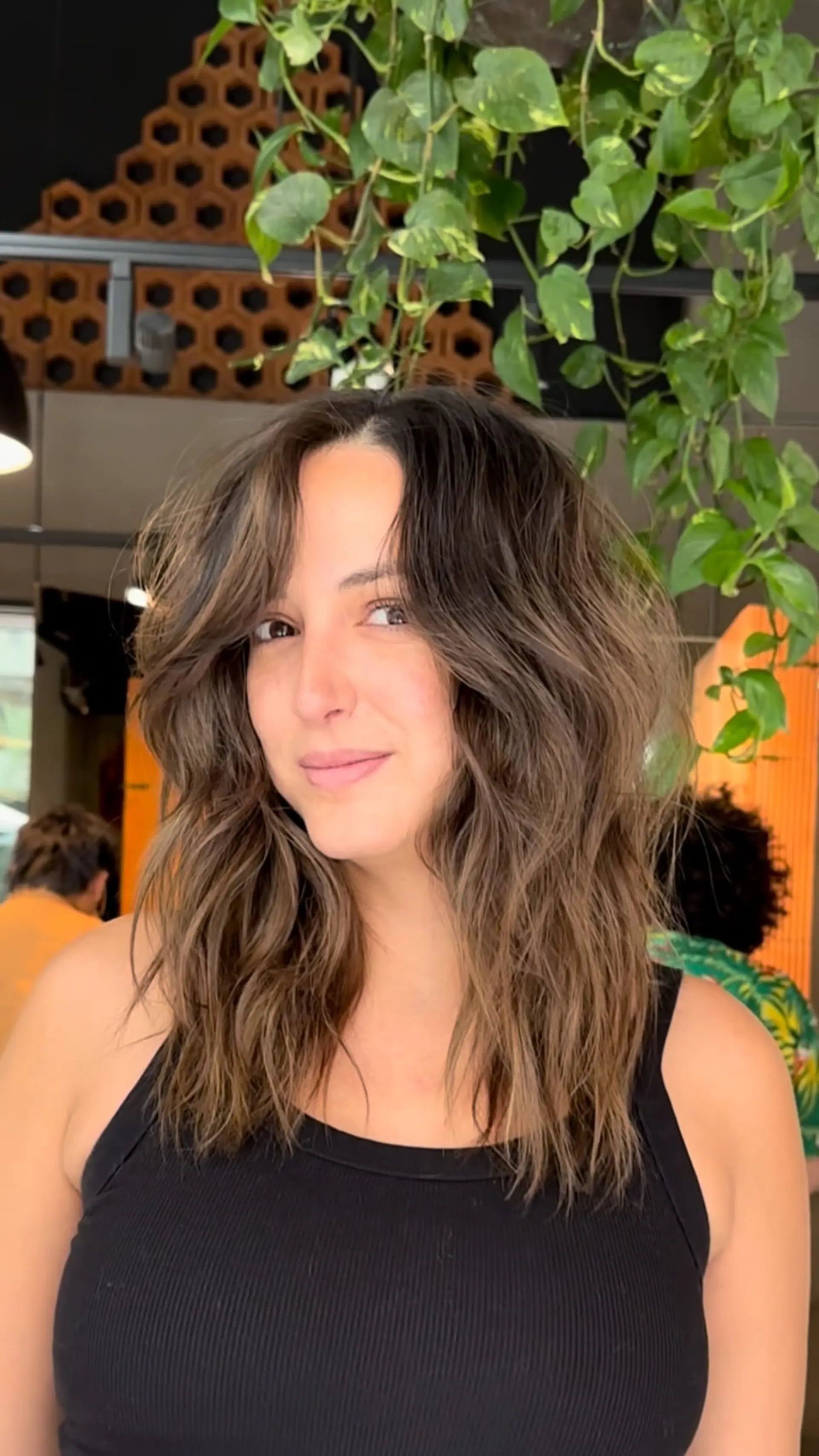 Medium-length textured layered shag styled with lived-in waves and soft dimensional brunette balayage. 1