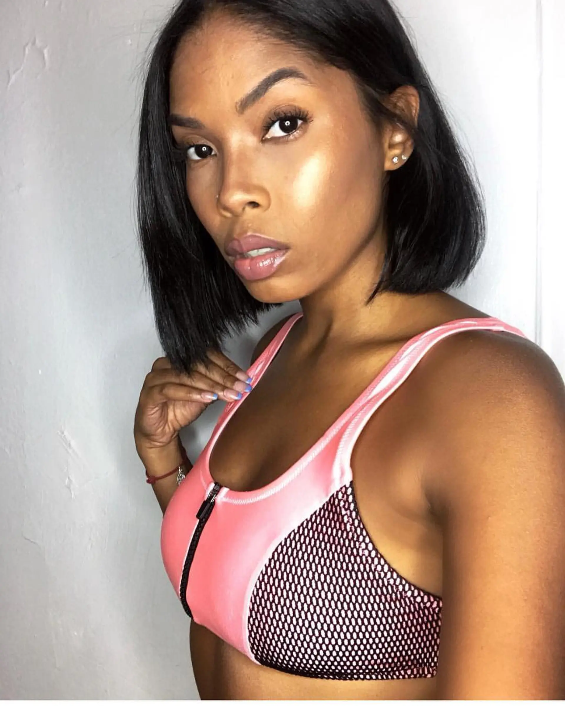 A sleek, chin-to-neck length blunt bob with subtle interior texture and a smooth finish. 1
