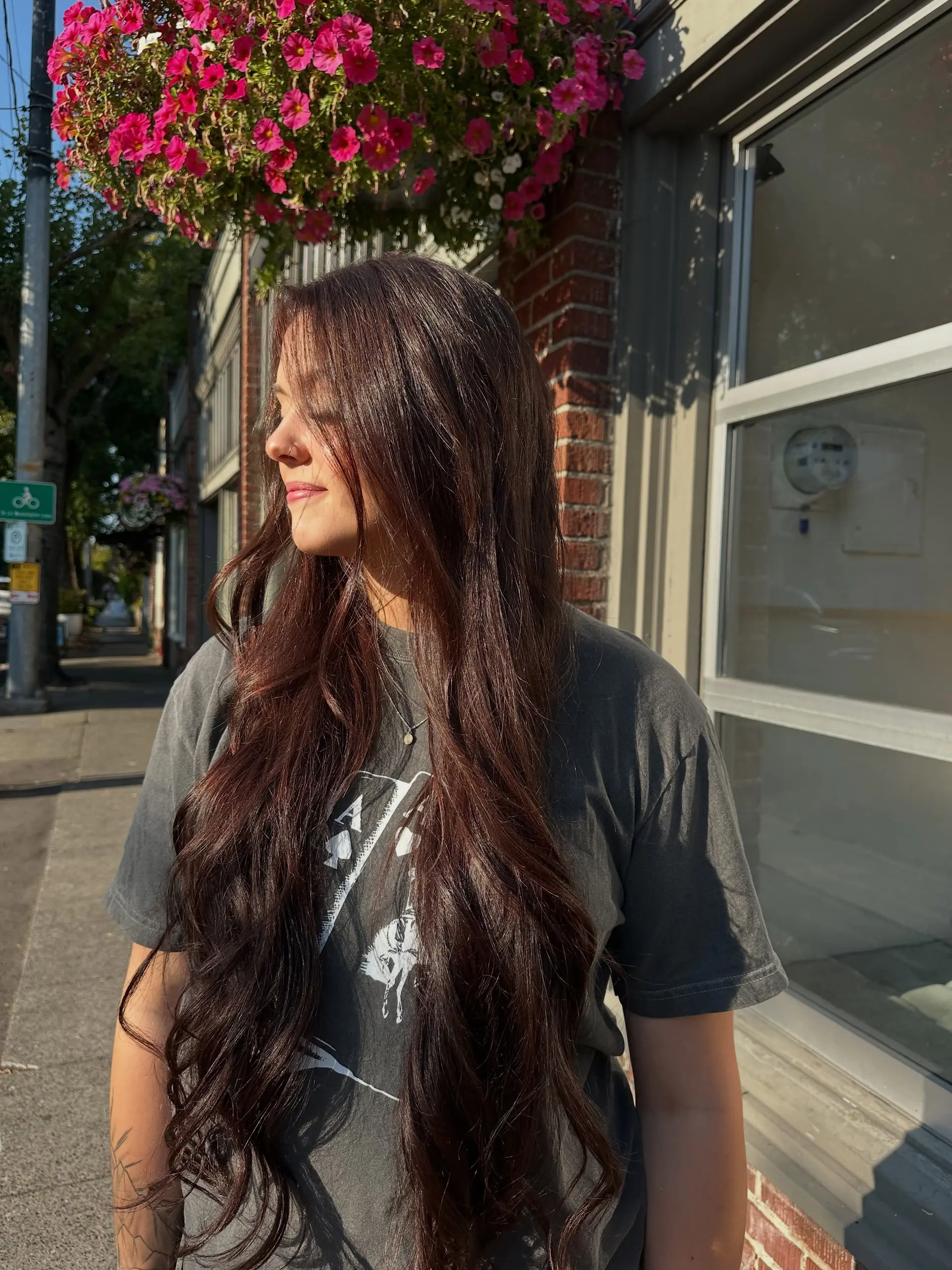 Extra-long rich brunette hair styled with soft, cascading loose waves catching natural sunlight. 1