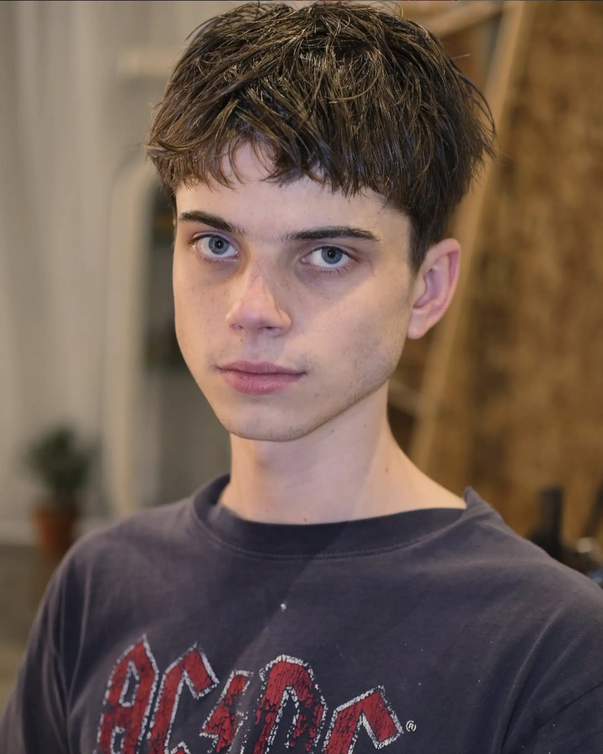 A short, straight, dark brown shaggy and tousled hairstyle with a textured fringe, providing a casual and messy look. 1