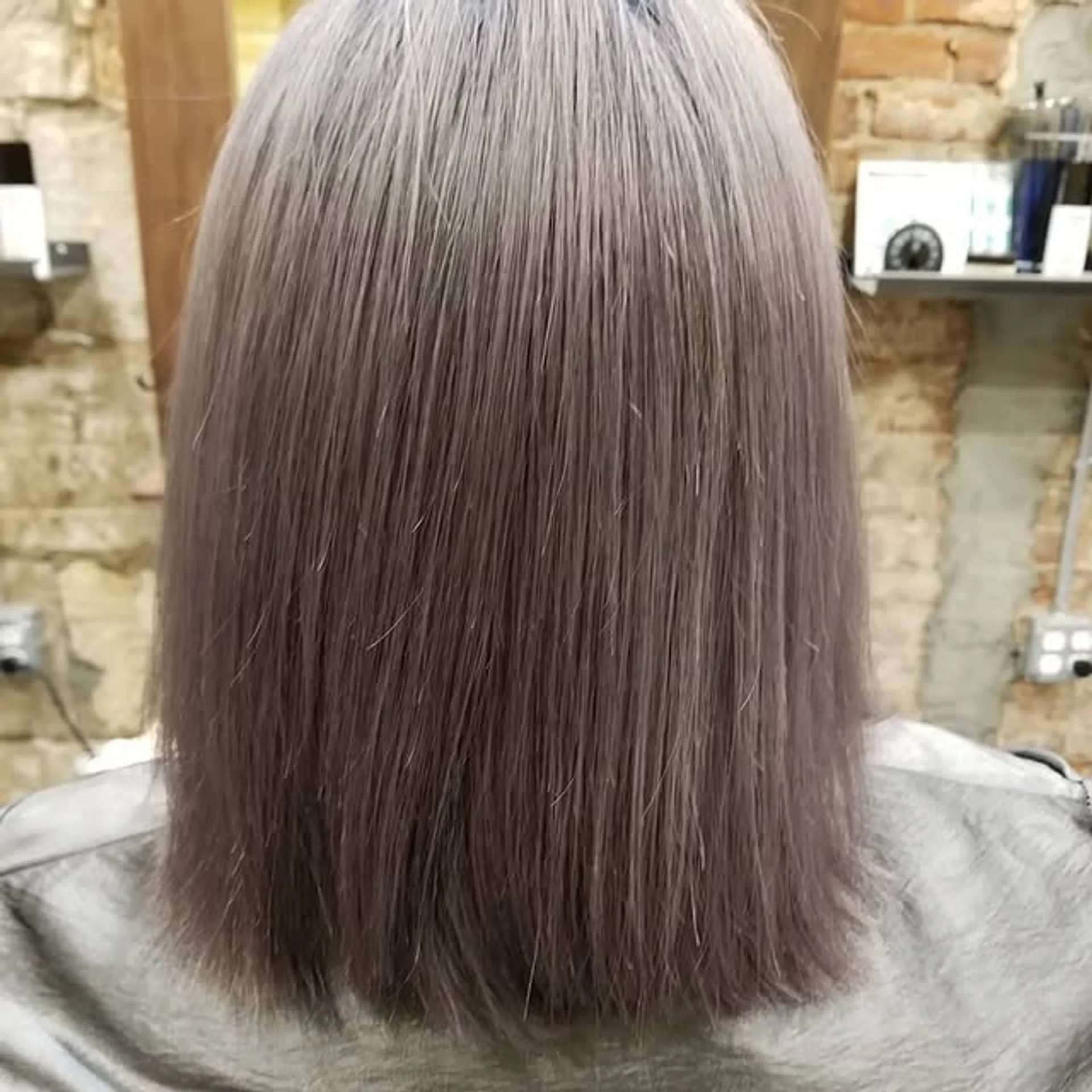 A model with long, sleek, straight hair dyed a vibrant pastel lavender, showcasing the Digital Lavender trend of 2026. - Preview 1