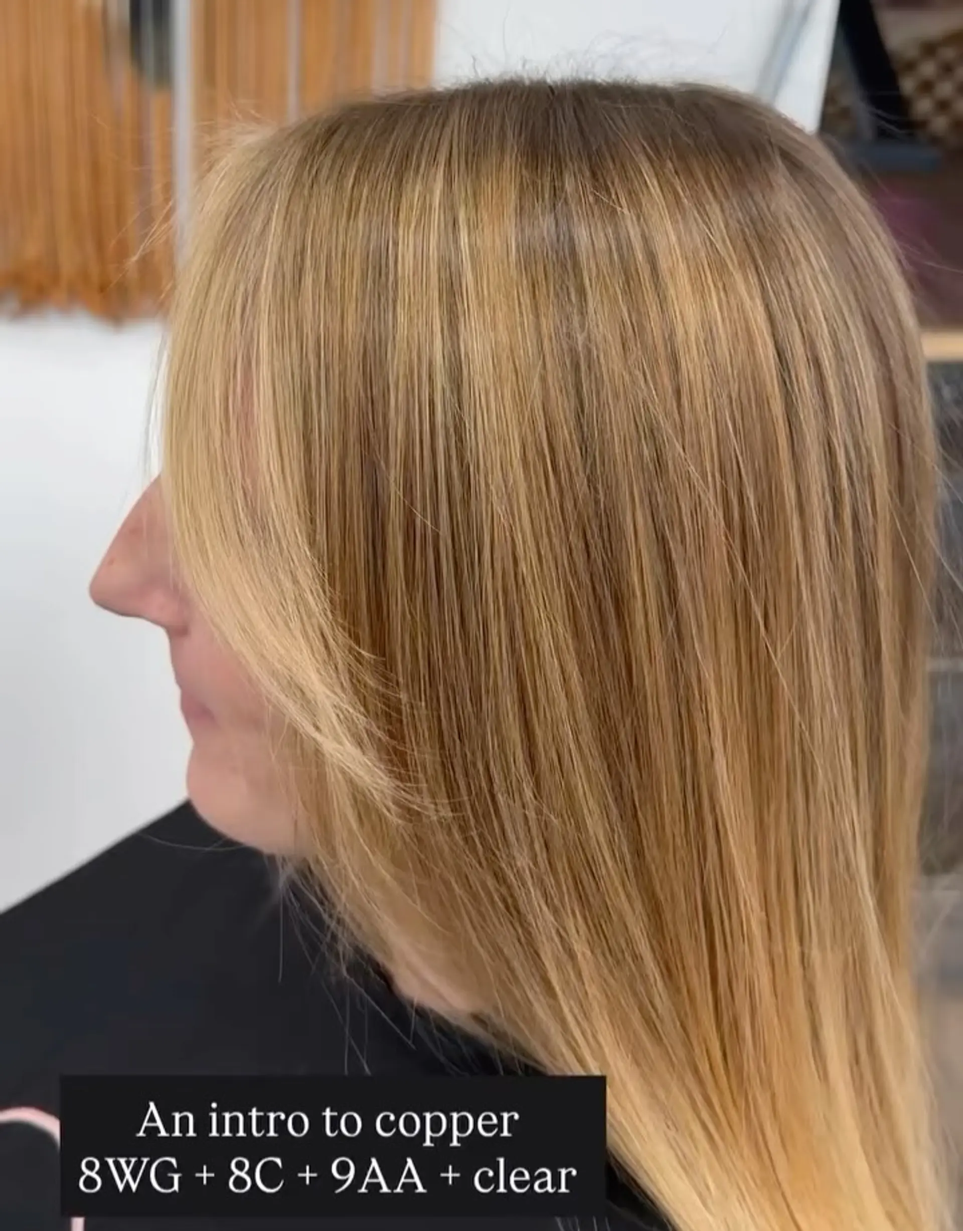 Sleek straight warm copper-golden blonde hair styled with soft, angled face-framing fringe. 1