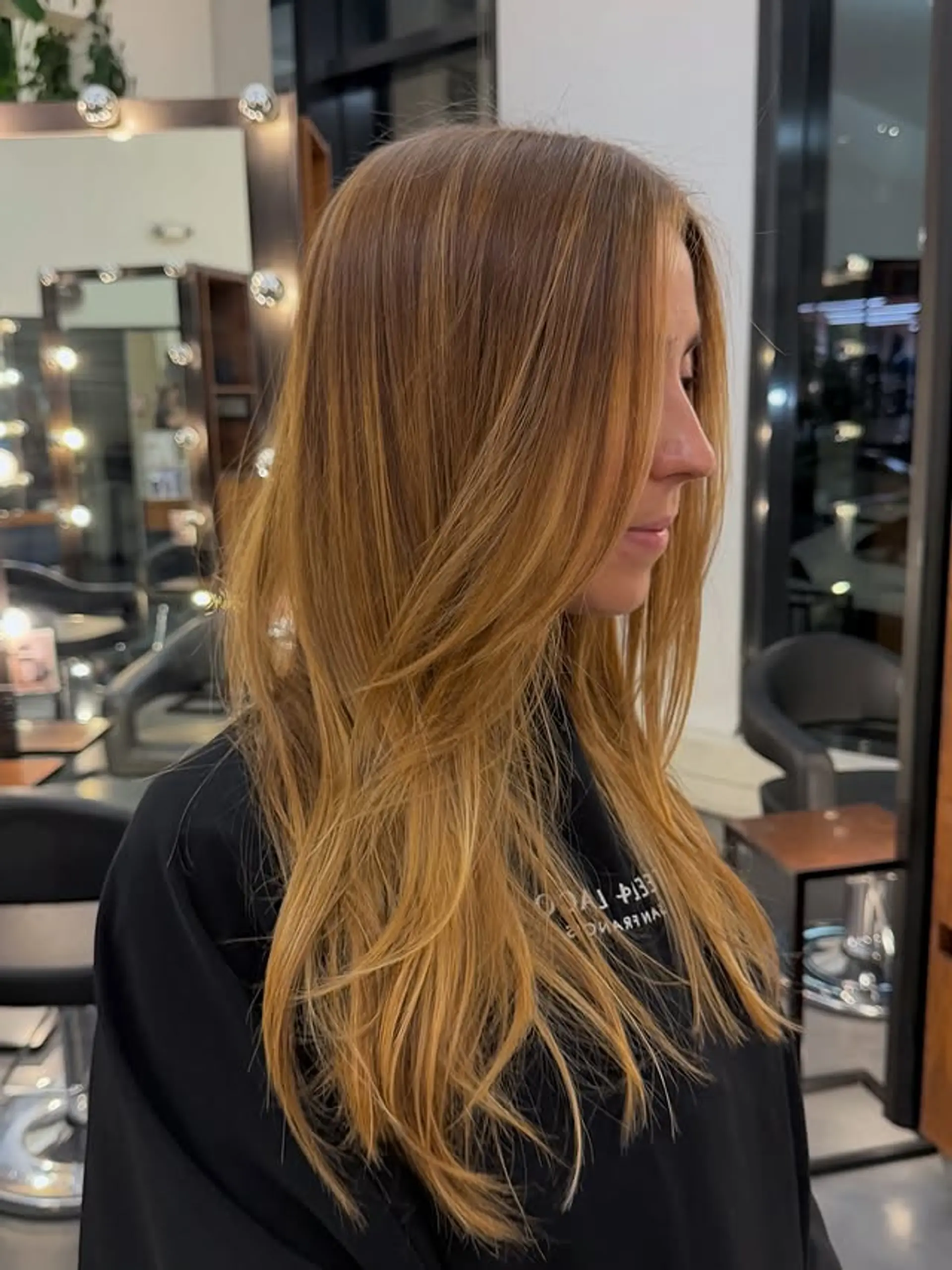 Long layered cut with face-framing layers and balayage color. 1
