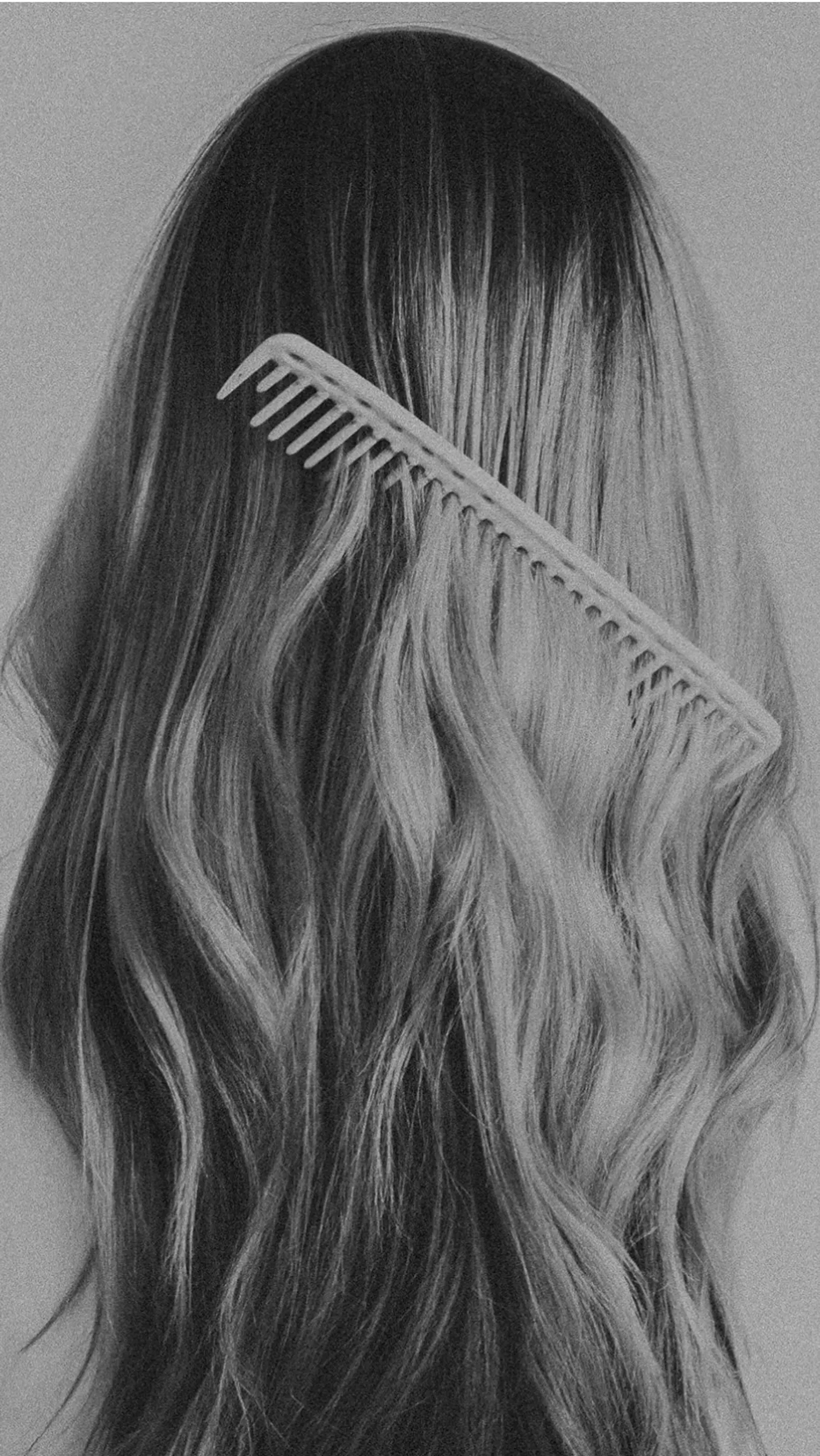 Long, flowing waves being gently combed through with a wide-tooth comb for a soft, voluminous finish. 1