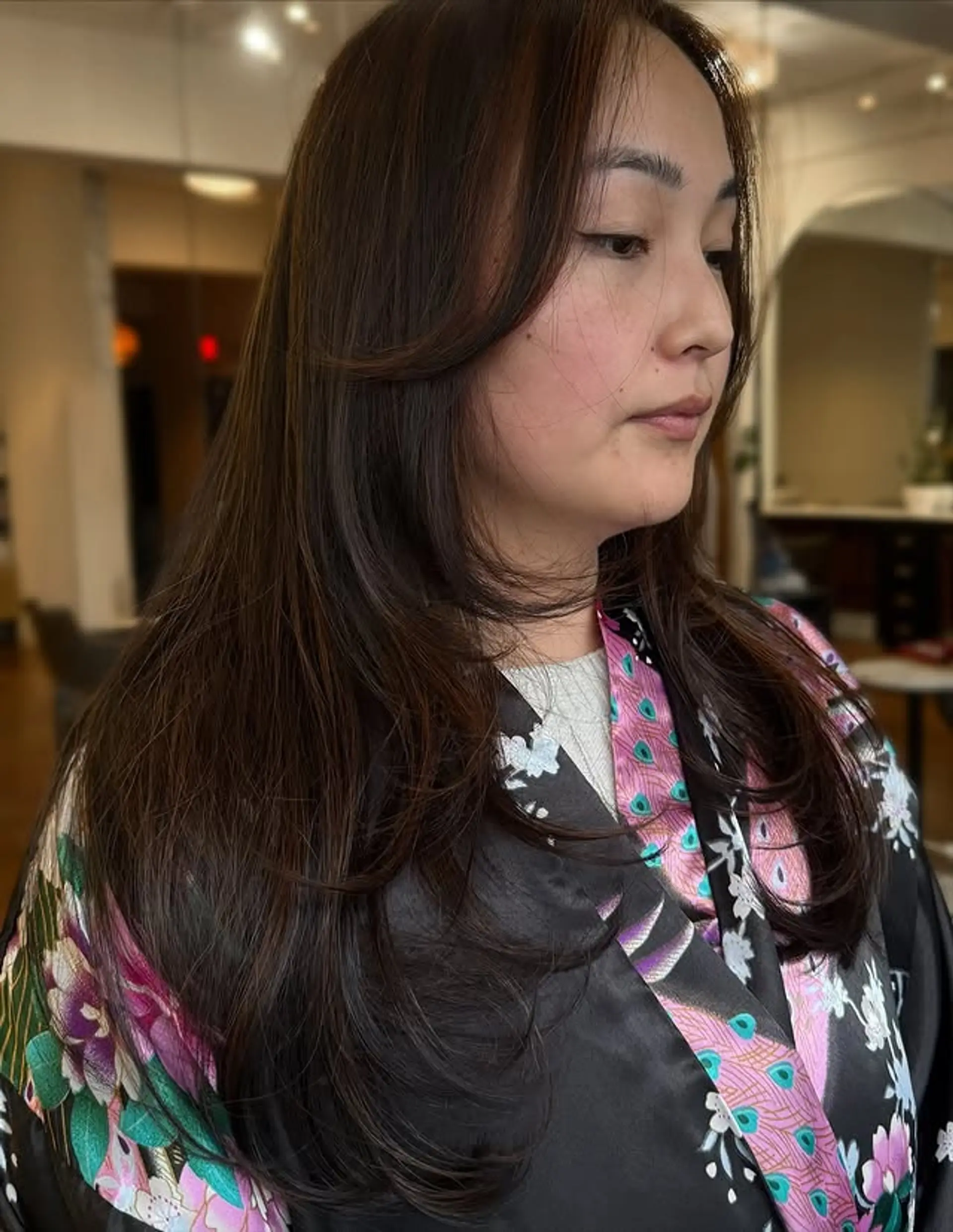 Long, layered haircut with face-framing layers. 1