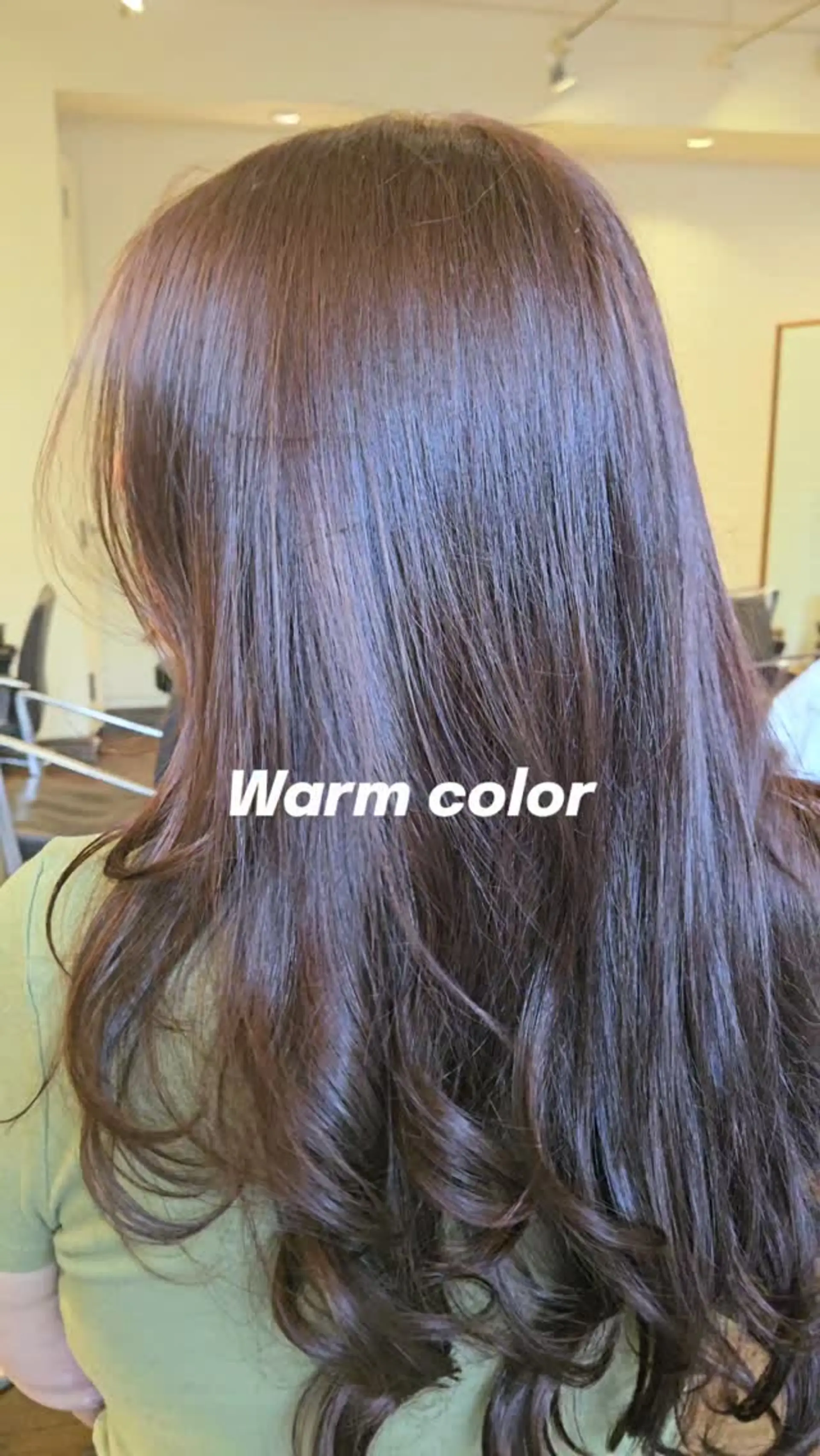 Long warm brown hair cut in soft layers and styled with polished curls at the ends. 1