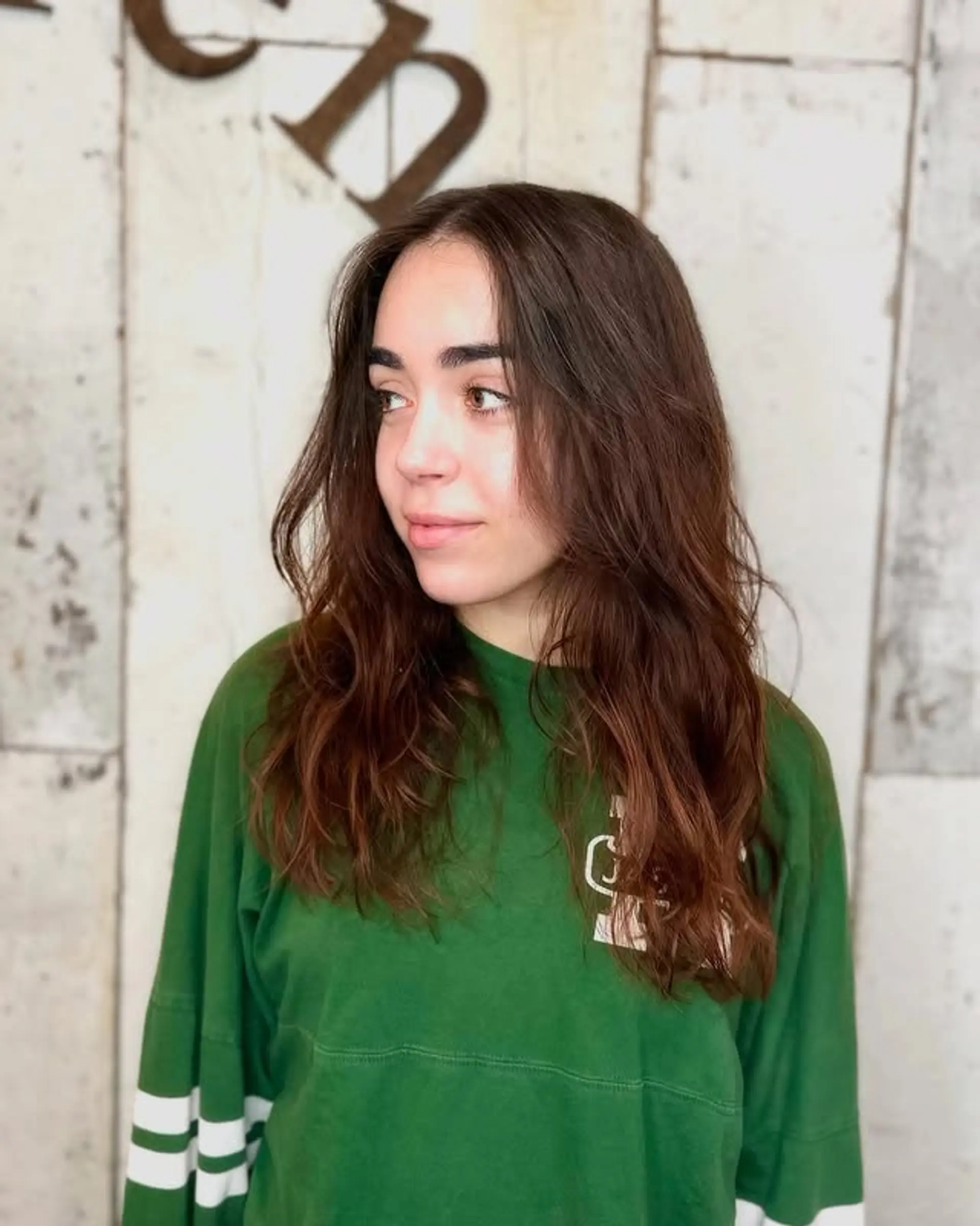 A long, layered, wavy hairstyle with a natural looking bronzed ends. 1