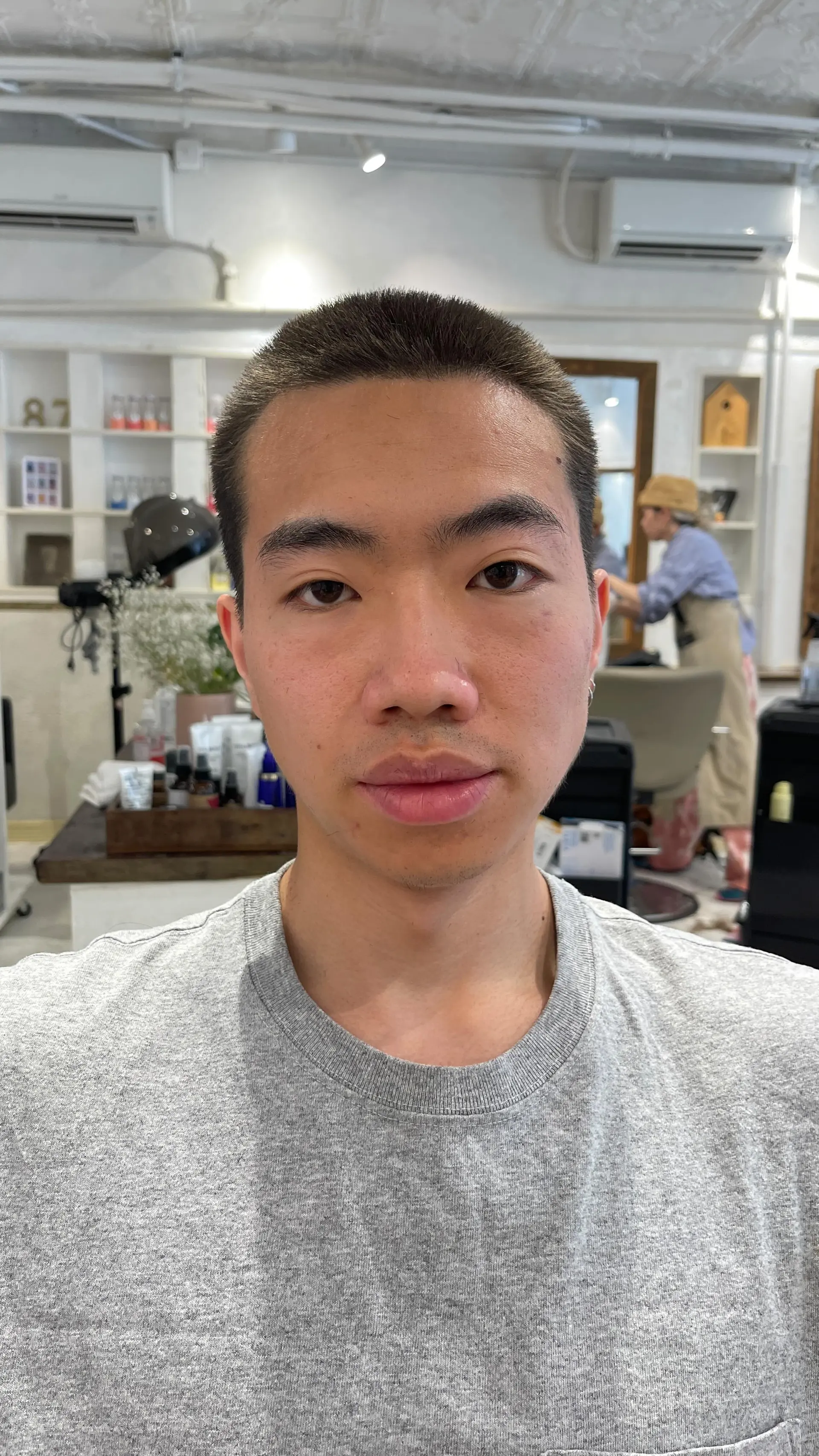 A clean, uniform buzz cut closely cropped all around the head. 1
