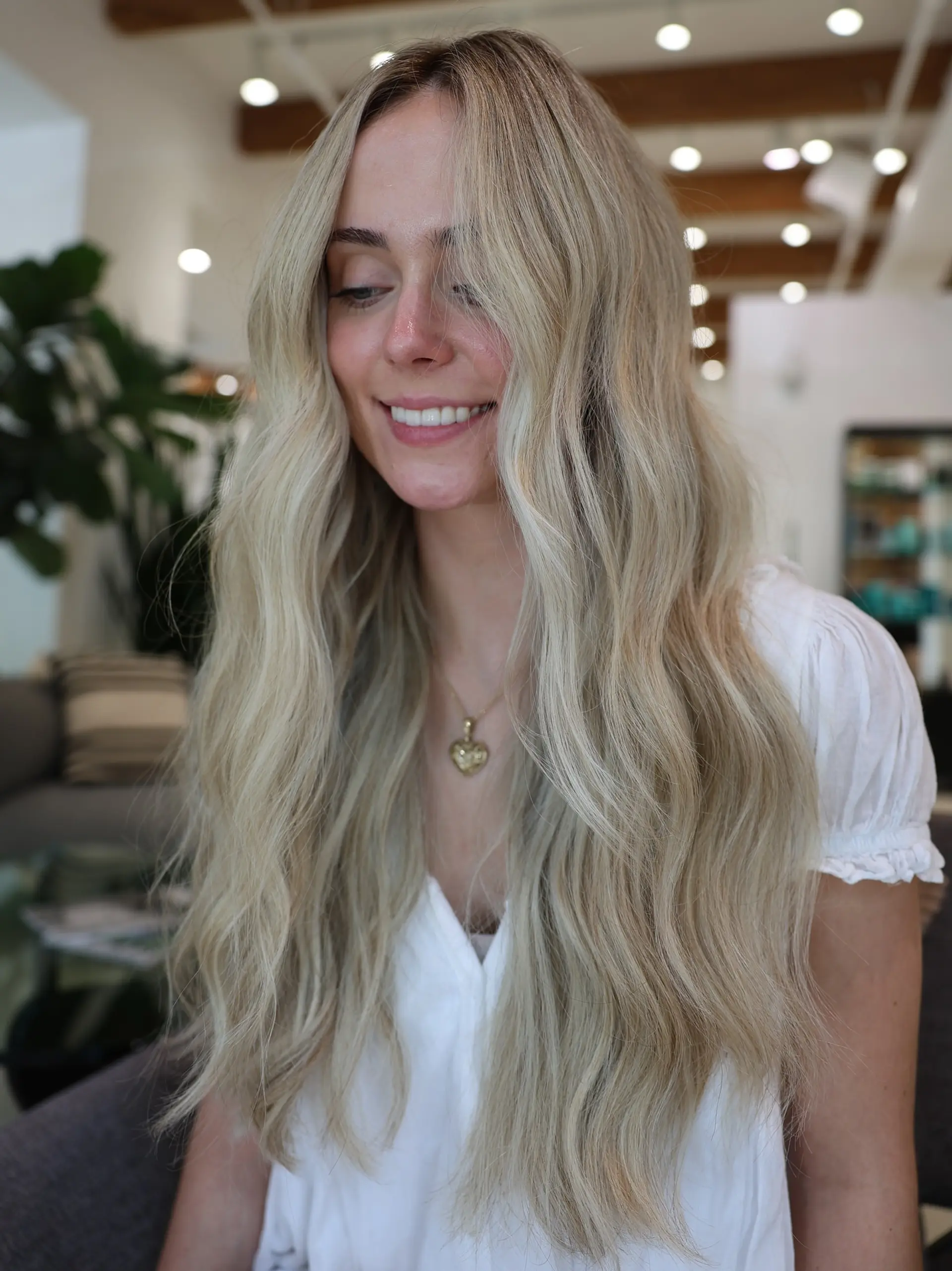 Long, flowing beachy waves with subtle layers and a natural, sun-kissed blonde. 1