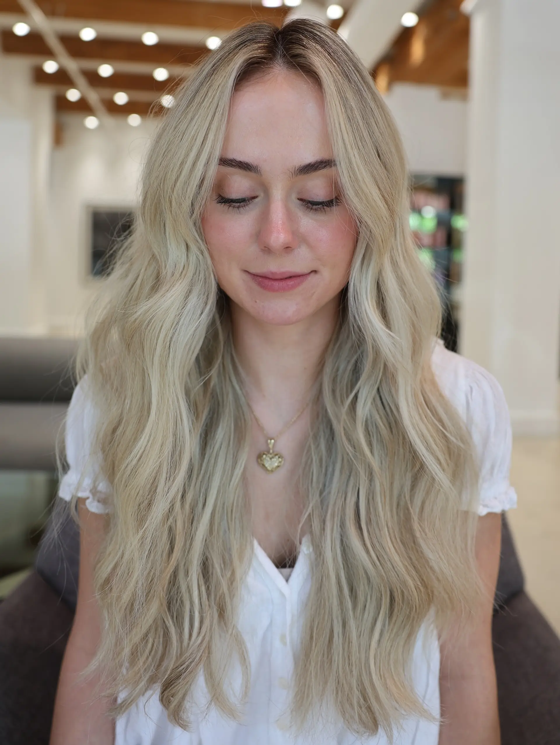 Long, flowing beachy waves with subtle layers and a natural, sun-kissed blonde. 3
