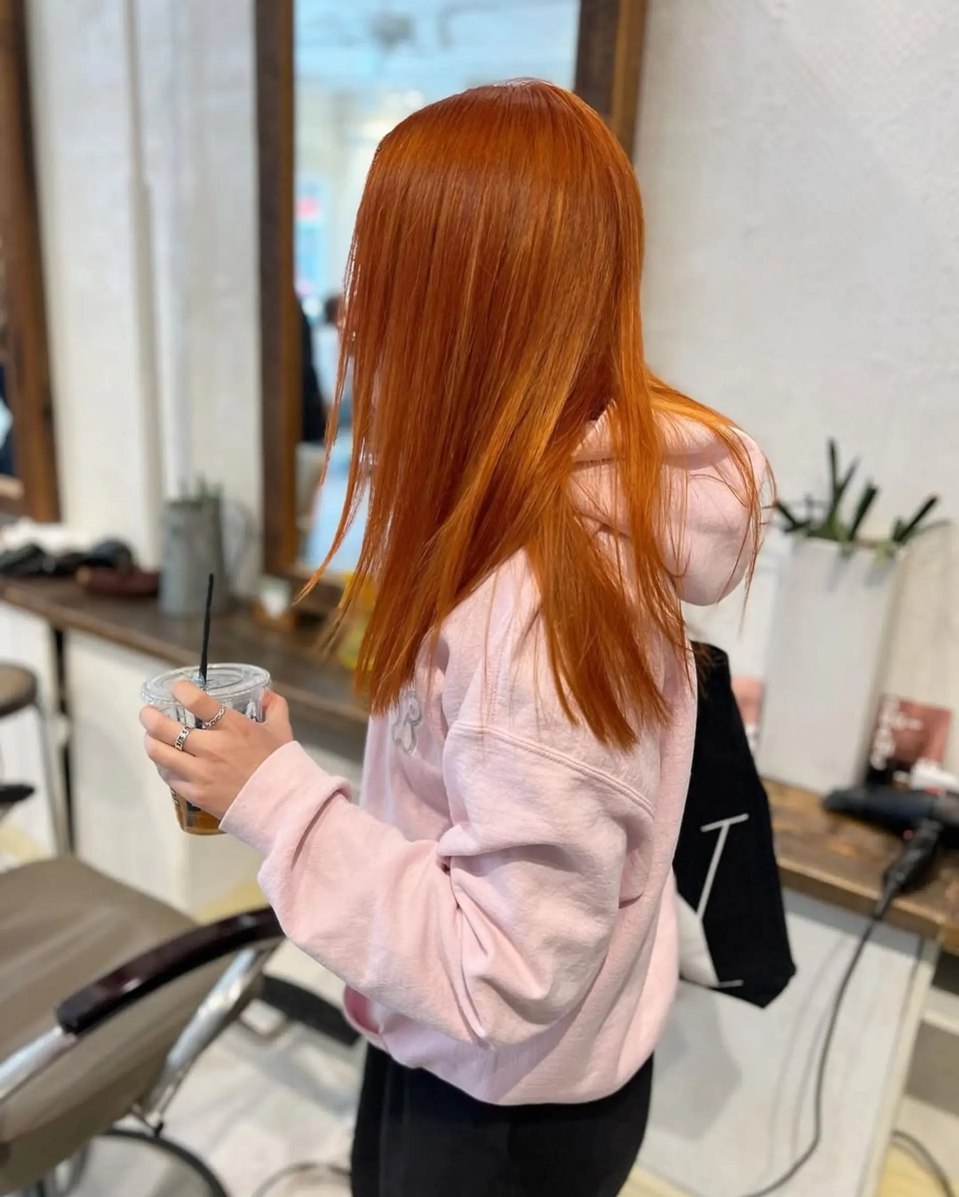 The hair features a vibrant copper shade, styled straight and long with a sleek finish. 2