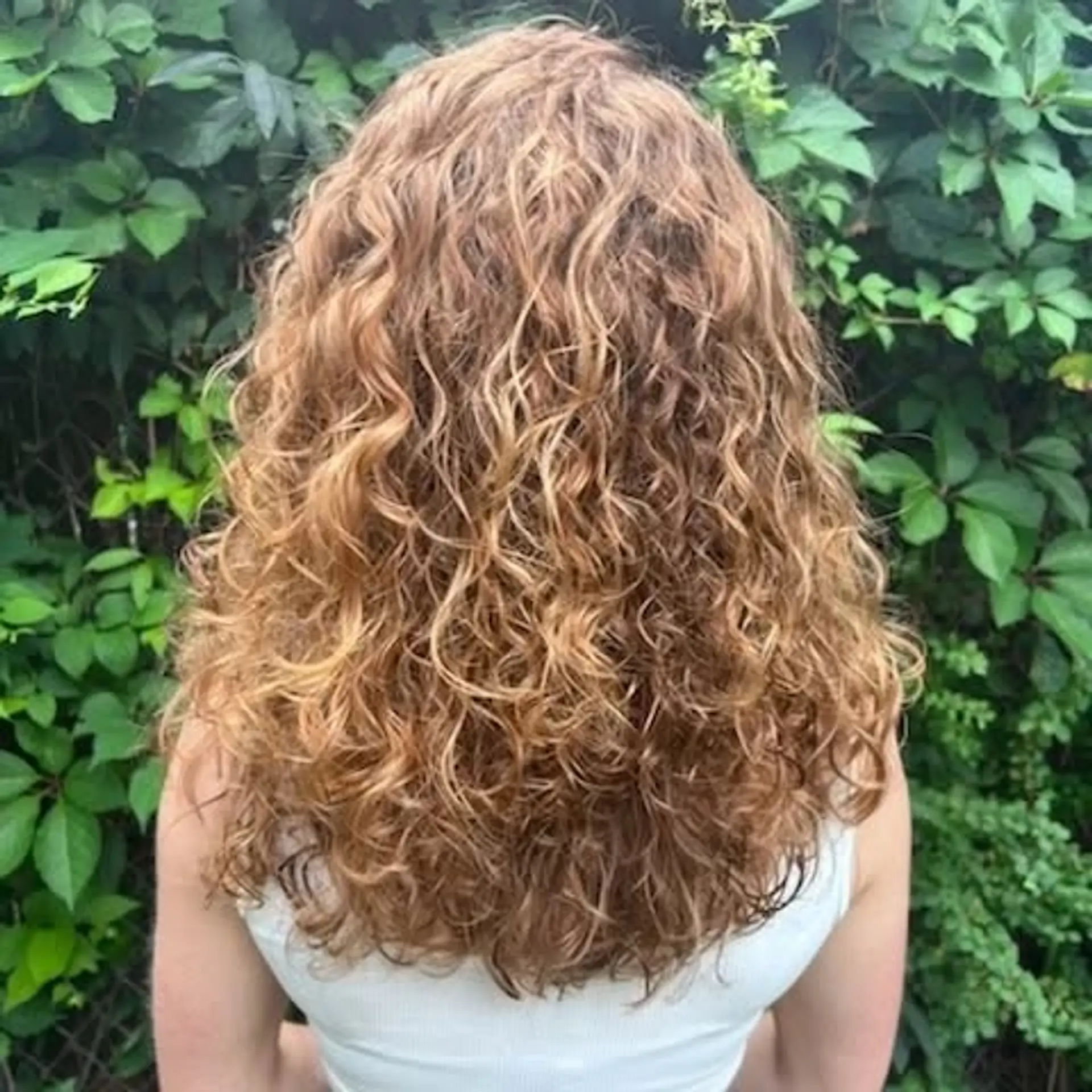 A cascade of defined natural curls in golden blonde. 1