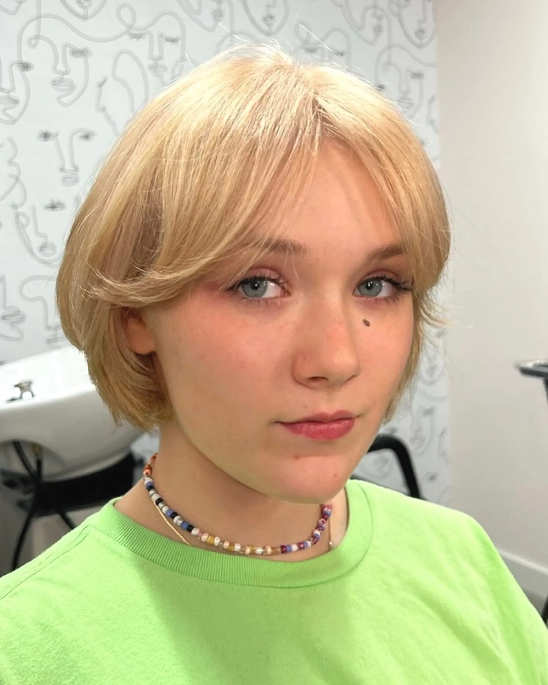 A bottleneck bob with curtain bangs, softly layered. 1