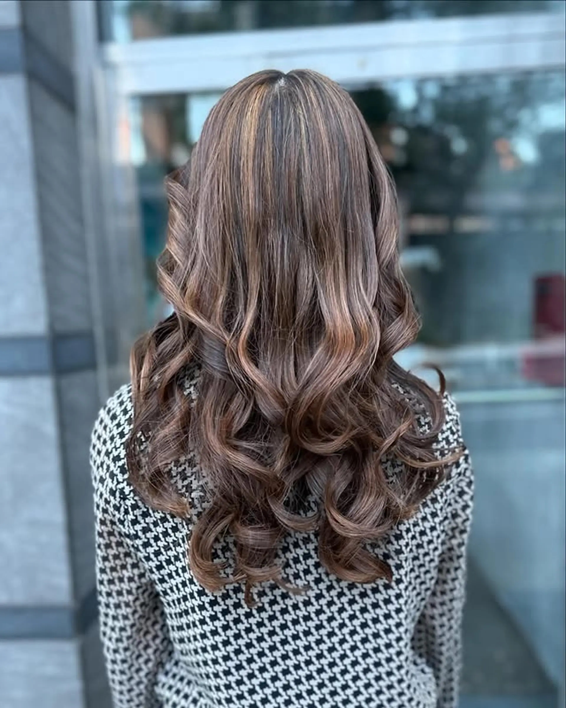Long brunette hair with blonde balayage highlights and soft, flowing waves. 1