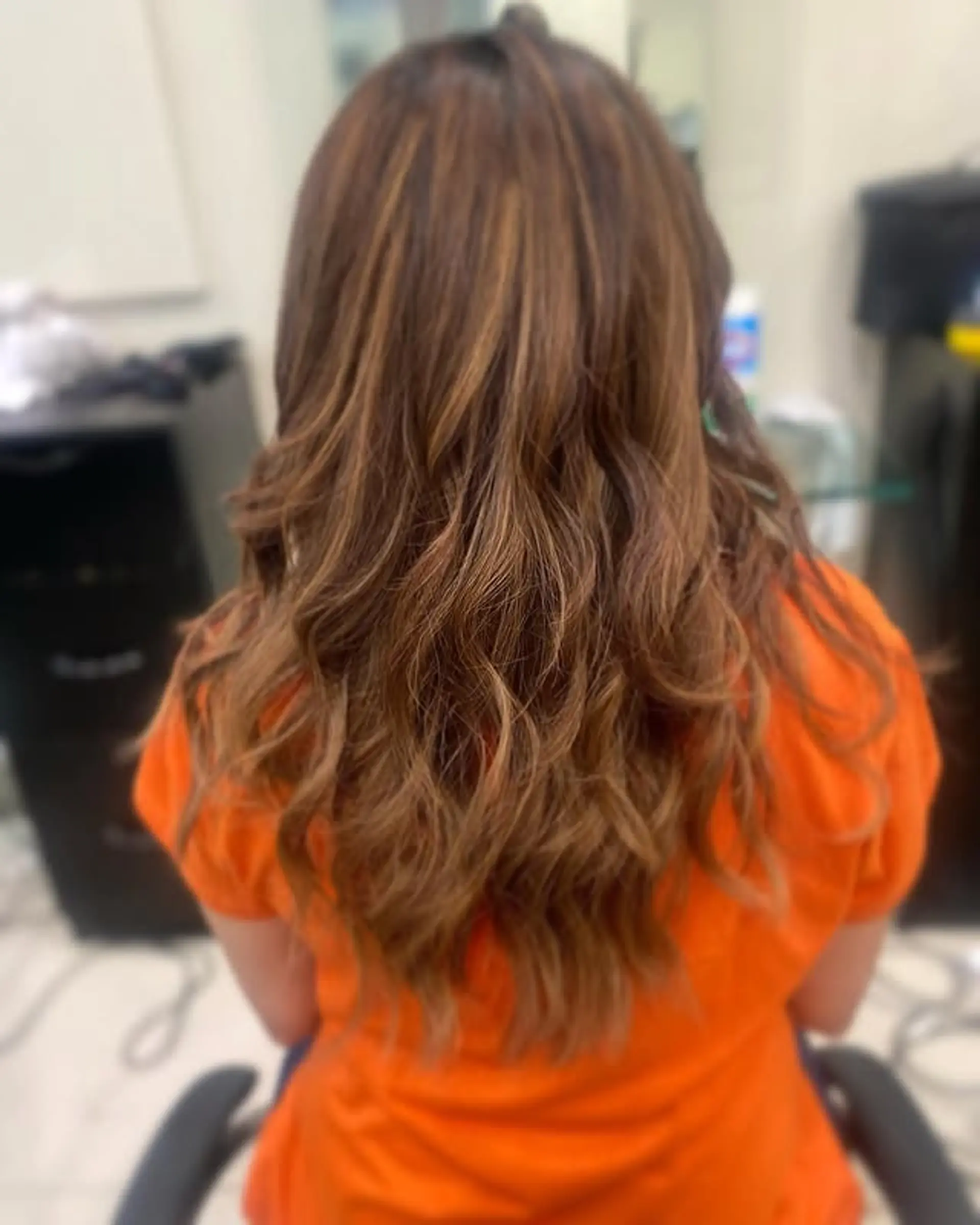 Long, wavy hair with caramel balayage highlights and layers. 1