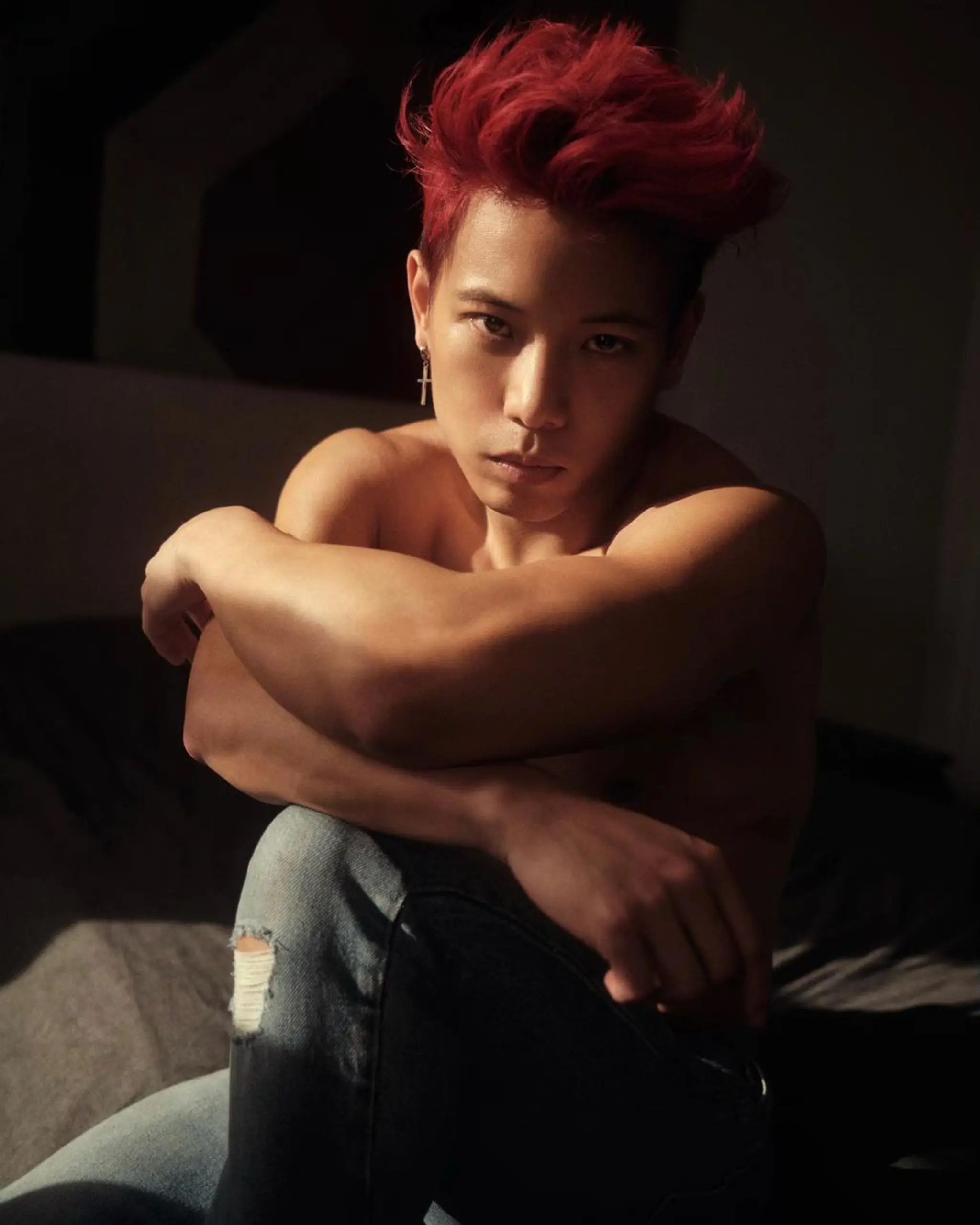 A vibrant red, straight hair styled in a dynamic and high volume quiff with textured layers and side-swept finish.