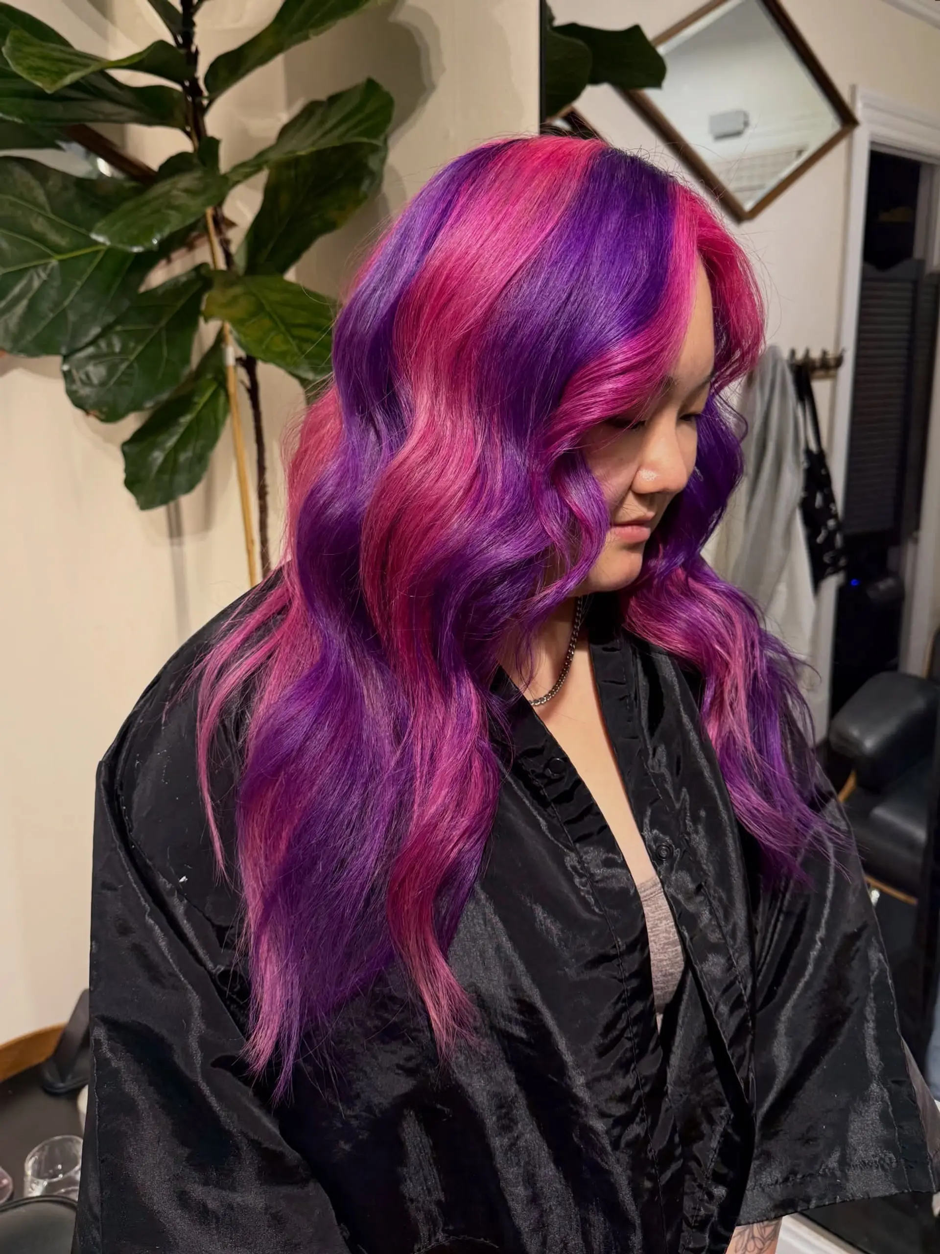 Long cascading waves colored in alternating ribbons of vibrant magenta pink and deep violet purple. 1
