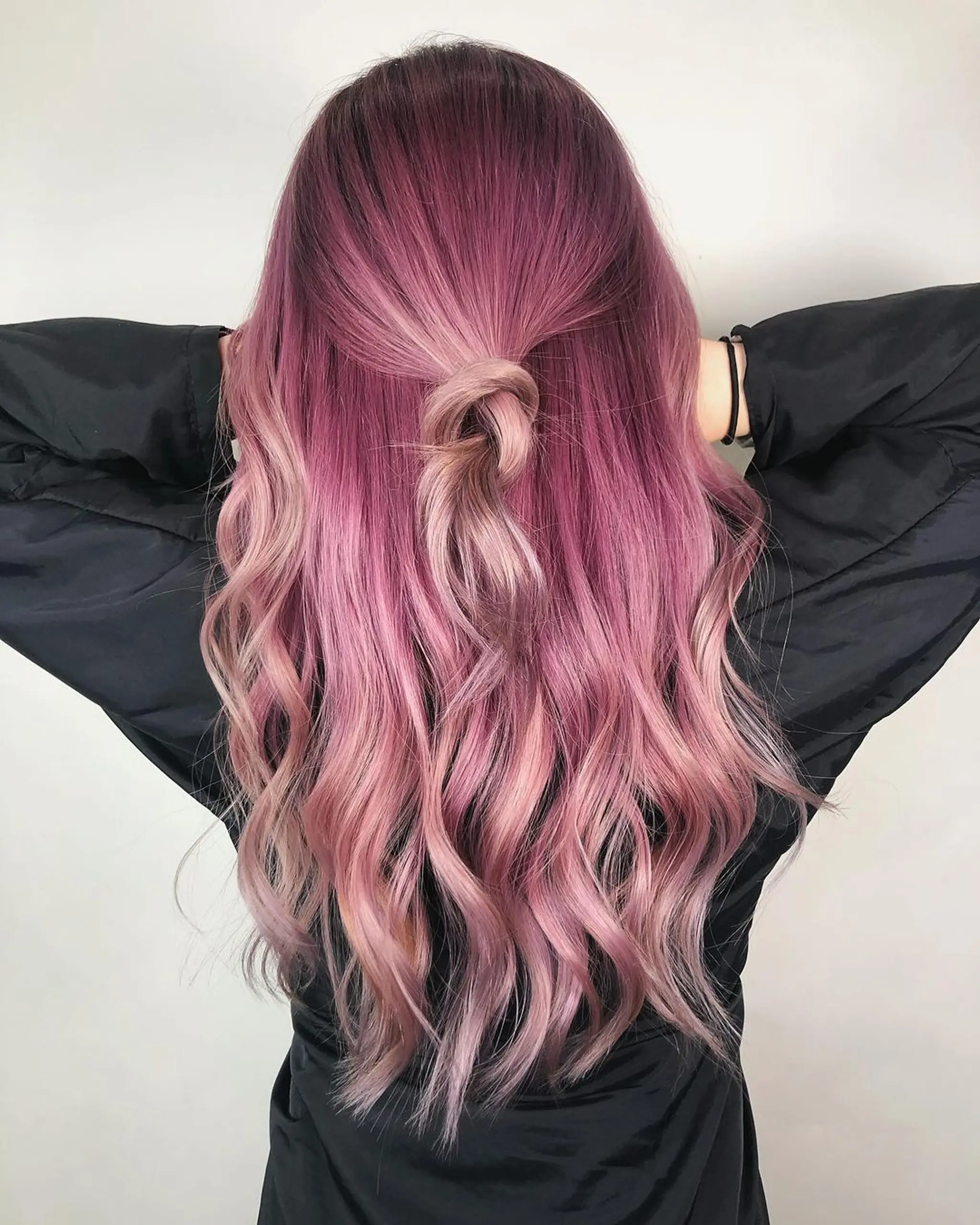 Long, softly waved hair in vibrant magenta, lavender, and blush pink, pulled into an intricate half-up knot.
Stylist - @xcellent_jason
