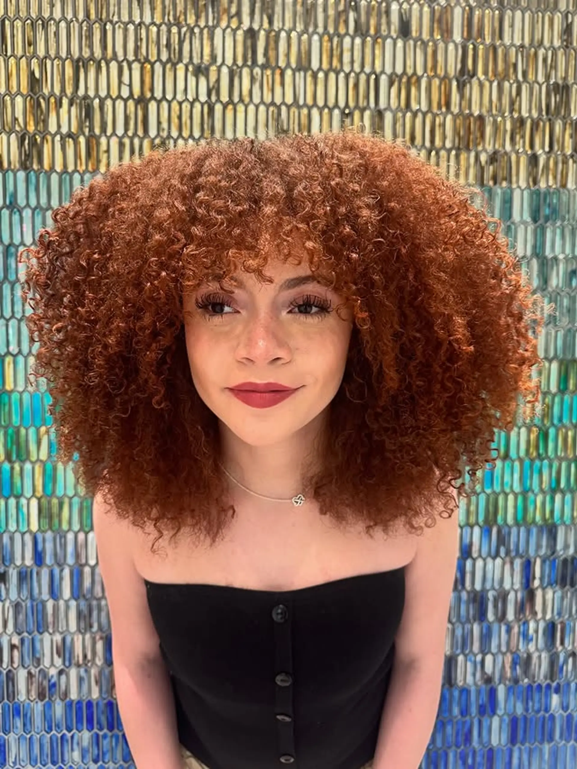 A curly bob with bangs featuring defined, voluminous curls. 1