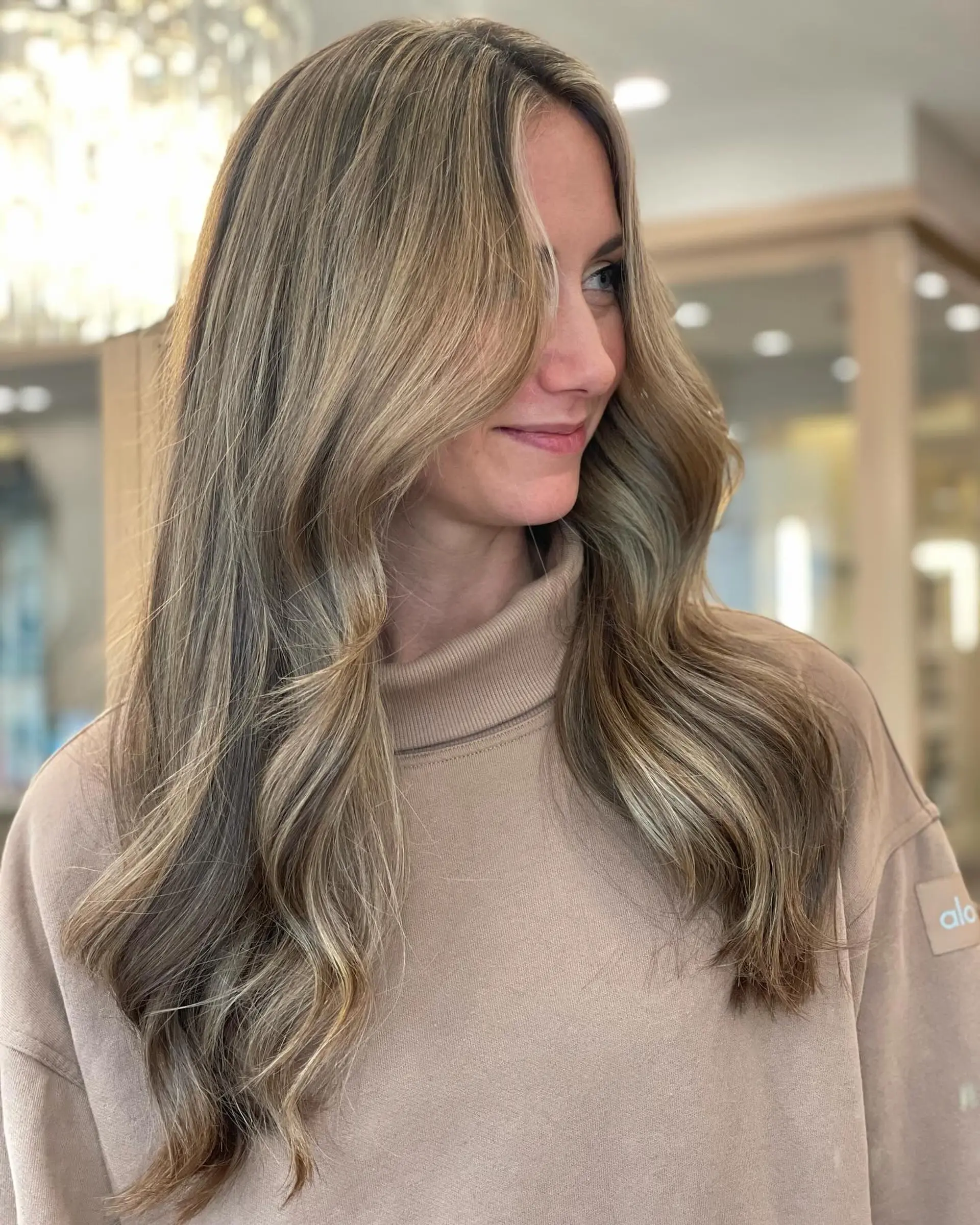 Long, soft waves with face-framing layers. Bronde color with a balayage effect. 1