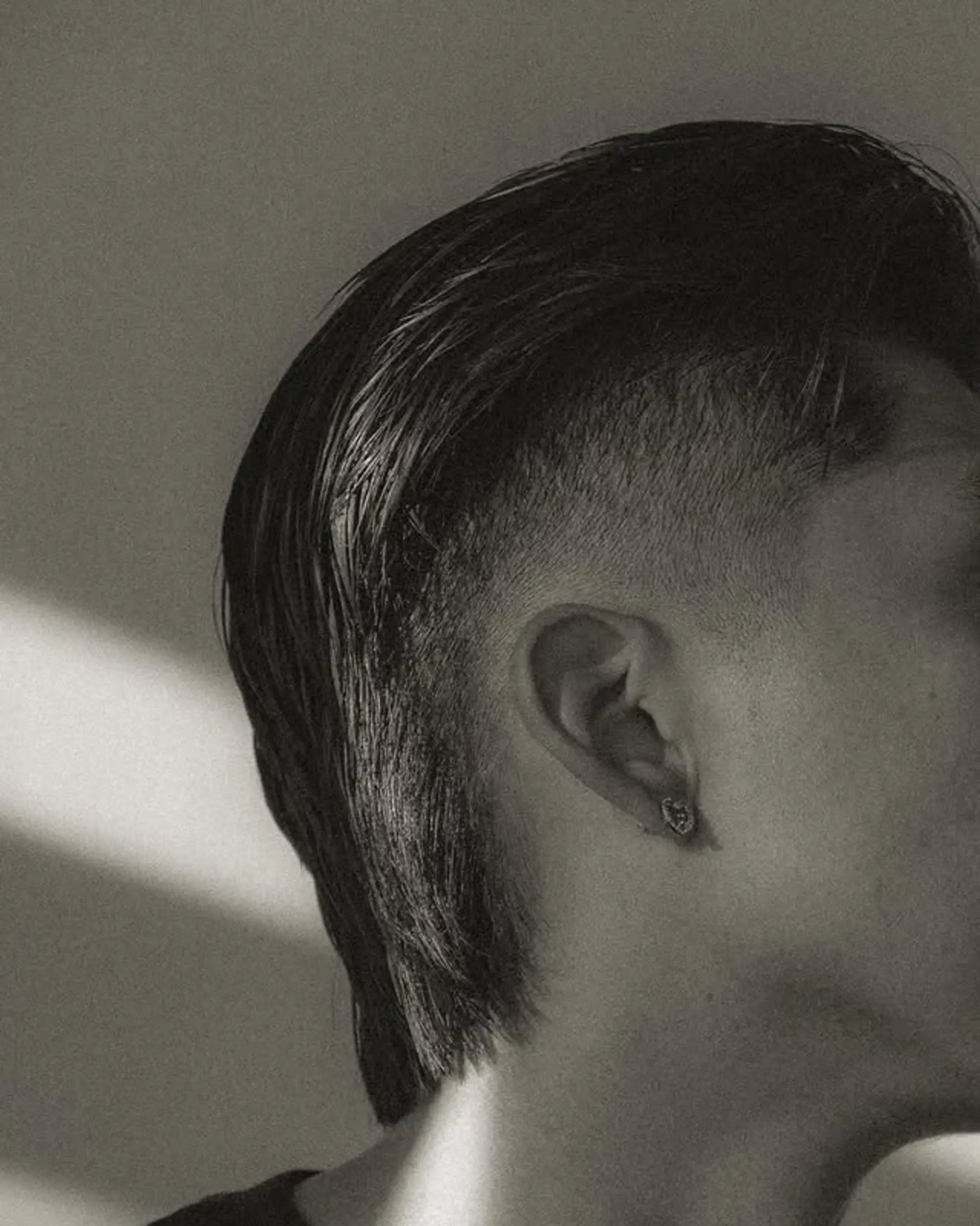 A modern mullet with a high taper fade, featuring a textured top that transitions into a longer length at the back. 1