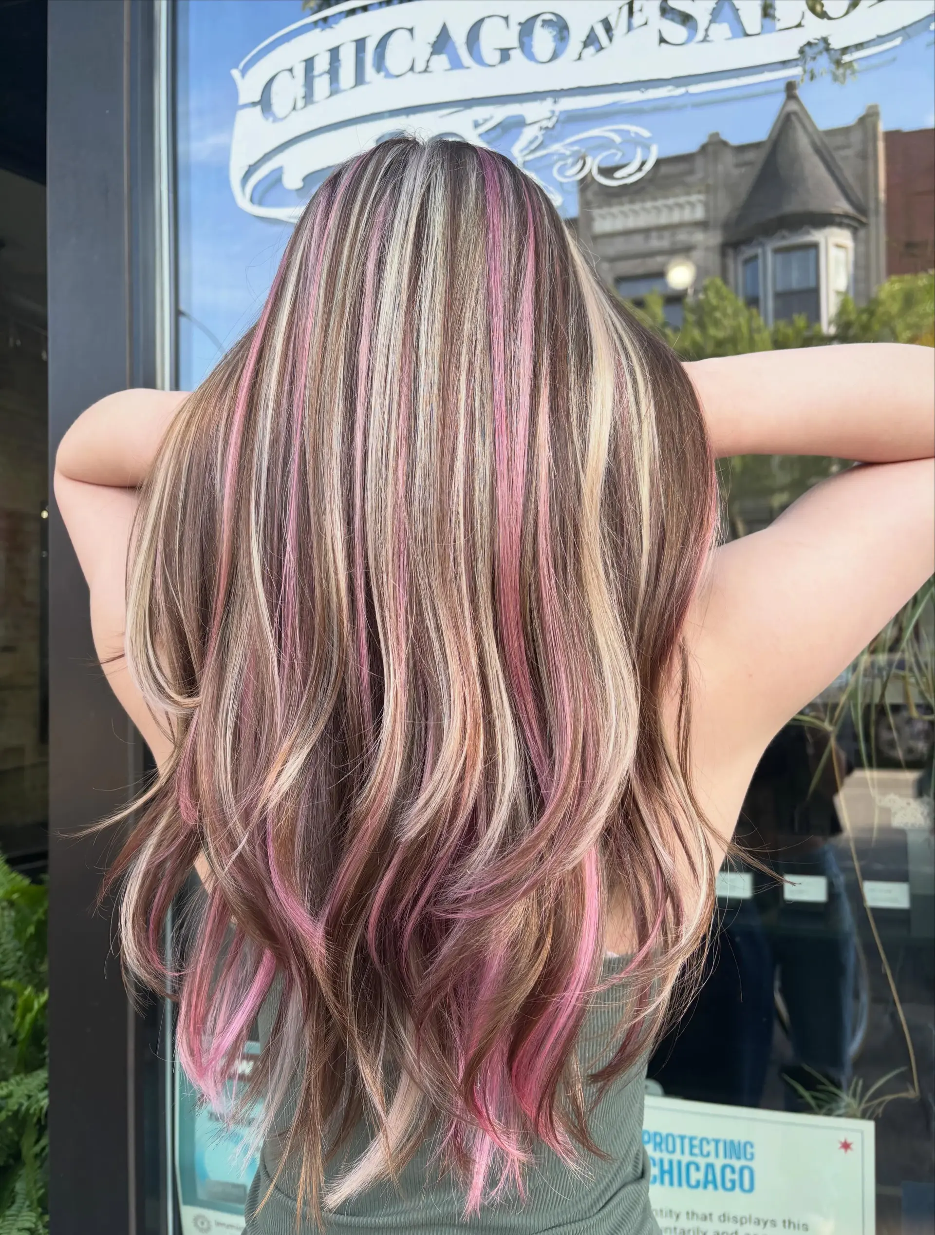 Long layered hair featuring tri-color 'neapolitan' highlights combining pastel pink, blonde, and warm brown ribbons with softly flipped ends. 1