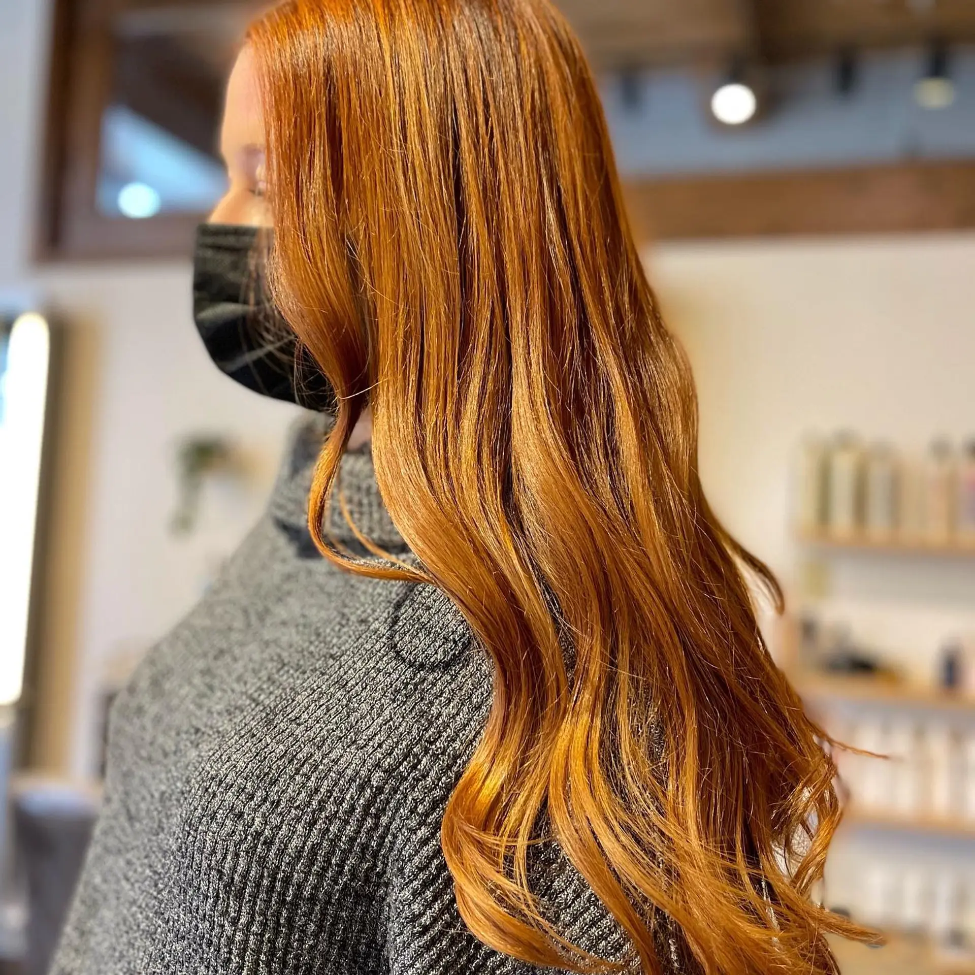 Long, wavy hair with a copper red color achieved through balayage. 1