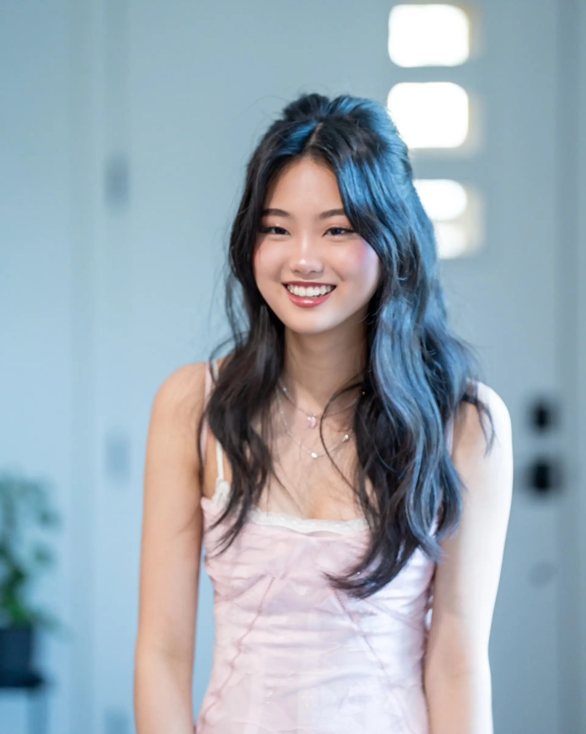 Half-up half-down style featuring soft, loose waves and face-framing strands. 1